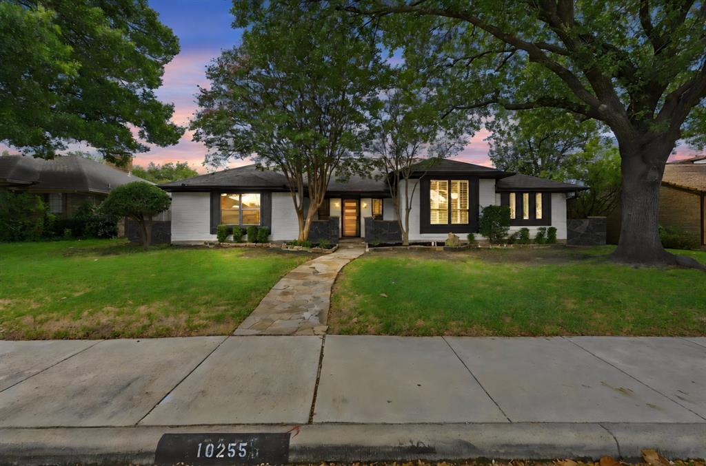 Welcome to 10255 Chimney Hill Lane – a beautifully remodeled 4-bedroom, 3-bath single-story home in the highly desirable Country Forest subdivision of Lake Highlands in Dallas. Situated on a .21 acre lot in Richardson ISD (easily walkable to Aikin Elementary), this property blends high end modern finishes with comfortable single-level living and outstanding outdoor amenities.Step inside to a floor plan that offers an abundance of natural light and features luxury wood-look flooring, high ceilings, and an elegant white brick fireplace that anchors the formal living room. This spacious formal living area flows seamlessly into the family room and kitchen, creating an ideal space for entertaining. The gourmet kitchen boasts crisp white custom cabinetry, quartz countertops, beautiful tile backsplash, gold-tone hardware, and a gas cooktop beneath a wooden range hood. Double ovens, soft-close cabinets and drawers, and ample storage bring convenience to the thoughtfully updated space.The upscale primary suite offers private pool access, an en-suite bath with dual walk-in closets and showcases dual vanities, an elegant freestanding soaking tub, and a frameless glass walk-in shower.  Two additional bedrooms share an expansive Jack and Jill bath with dual sinks and a large scale heated mirror. For guests, the third full bath near the family room features stylish blue tile and is also easily accessed from the backyard. A dedicated office or fourth bedroom with closet adds even more versatility. The private backyard retreat features an in-ground gunite pool with spa, a soothing waterfall, covered breezeway, and a charming open air central courtyard space, all enclosed by an 8 ft privacy fence. With approximately 2,546 sq ft of living space, this move-in-ready home delivers the perfect combination of modern style, function, and outdoor enjoyment in one of Dallas’s most sought-after neighborhoods. Don’t miss your opportunity to own this exceptional property.