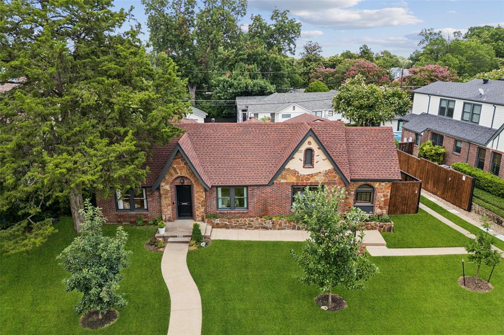 A rare opportunity to own an exquisitely updated Tudor on a sprawling third-acre double lot in the heart of one of Dallas' most charming and tightly knit neighborhoods, Hollywood Heights. Nestled on a prime block and zoned to highly acclaimed Lakewood Elem, this home is ideal for those seeking both sophistication and a strong sense of community. The storybook curb appeal, with fresh landscaping sets the tone for the refined interiors. The formal living room features a quartz-clad fireplace, designer wallpapered entry and a stylish built-in bar. The updated kitchen is both beautiful and functional, showcasing custom cabinetry, marble counters, premium appliances (including wine fridge), and a built-in breakfast nook with sweeping views of the expansive deck, backyard and pool. The primary suite is a serene retreat with a completely renovated bath with custom tile and a charming stained-glass window. Two generously sized guest bedrooms share a tasteful hall bath with marble counters, period tile and statement wallpaper. Step outside to your breathtaking backyard oasis, complete with a HUGE deck overlooking an oversized pool and spa, cabana, firepit patio AND a spacious lawn. The rare double lot provides a true sense of space and flexibility with potential to add square footage if desired. Located just minutes from White Rock Lake, Lakewood Village, Tietze Park and the Santa Fe Trail, the home offers walkability to parks, shopping, dining, and more. Residents enjoy a rich neighborhood tradition, including the beloved Hollywood Heights Easter Parade, adding to the small-town charm and community spirit that make this area so special. A perfect blend of architectural elegance, modern updates, and lifestyle convenience, truly one of East Dallas’ most coveted and idyllic homes.