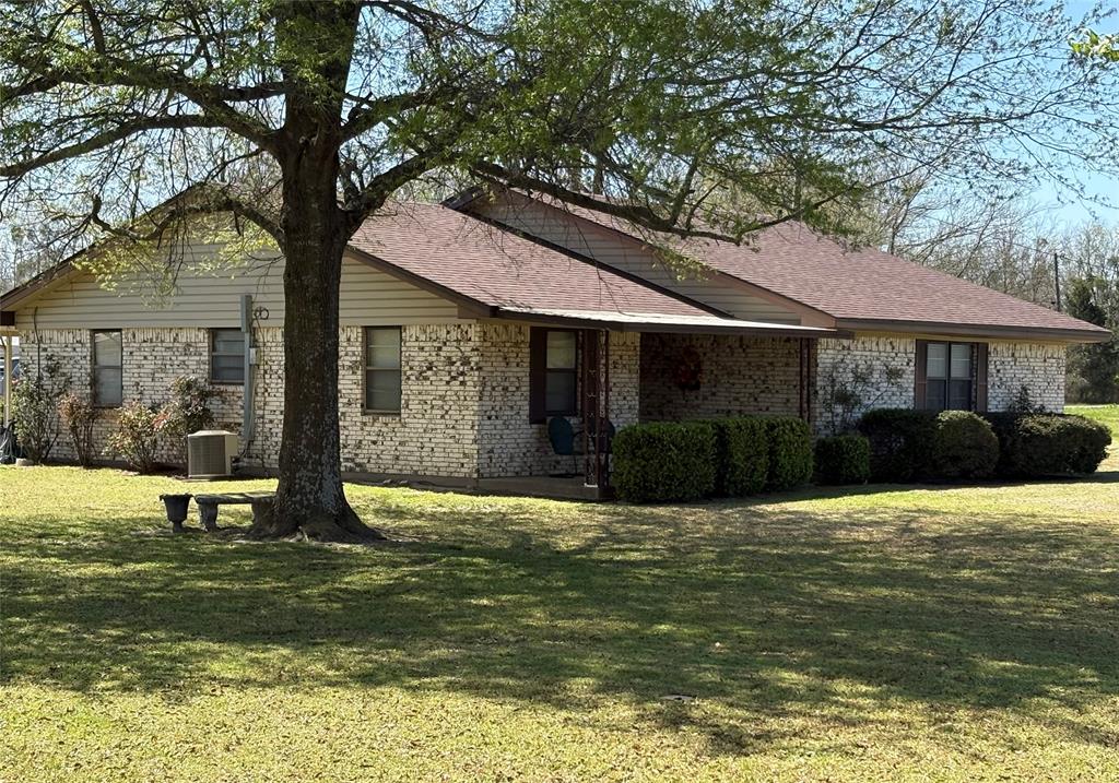 Opportunity knocking with this well maintained 3 bedroom brick home with multi-use shop located in high visability area. Providing a corner lot with access on 3 sides allows for a great place to live and operate a business. This cozy 3 bedroom has no wasted space and the open concept from living area to kitchen makes it very appealing and spacious. The kitchen also has a bar area for added eating space, custom cabinets and alot of counter space. Bedrooms have ceiling fans and the master has a half bath. The attached garage opens to a large covered patio for relaxing and entertaining.The shop (26x45) has two roll up doors, bathroom and plenty of storage space. The shops location (Hwy 11 & FM 2653 intersection) provides opportunity with high traffic volume and visibility as a great location for retail, repair, mechanic shop, fruit stand, etc. The road frontage on 3 sides allow for plenty of space for truck access and parking. Also on the property is a covered (14x38) RV parking with slab and electricity. There is also a small storage building located near the house for additional storage. Located between Sulphur Springs and Commerce and only about 4.5 miles from I30 makes this a great location for multi use.