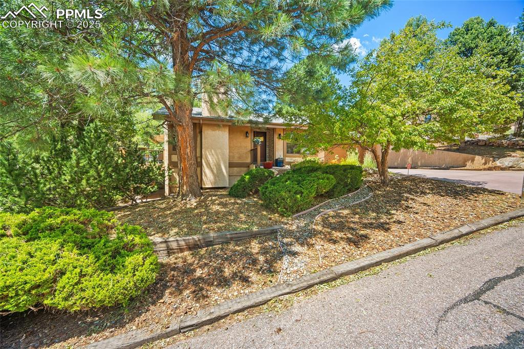 Welcome to this well-cared-for, custom, westside home. Pride of ownership and obvious enjoyment are evident in every single room. One level living for aging in place with main level including expansive master suite, complete with walkouts to the back patio and the side deck, a separate office area, and a generous master bath. Main level also includes laundry room, kitchen, dining area, living area and guest suite currently used as an art studio by owner, a notable local artist. The walkout basement includes 2 large bedrooms with a shared 3/4 bath, a family room with storage closets and built-in desk, and a craft room or art studio space with a walkout to a lower level patio surrounded by mature trees and access to the 1/4 acre lot. The garage includes a man door to the back patio garden area and a small workshop or storage room. High Point Gardens is a small and unique neighborhood built-out mostly between 1960-1985 with custom homes, many still occupied by the original owners. Residents enjoy direct access to Sonderman Park Open Space via a neighborhood trail. The neighborhood boasts many homes designed by local architectural legend, Elizabeth Wright Ingram. This home is less than 5 minutes to downtown, 2 minutes to the highway, 7 minutes to Garden of the Gods, 5 minutes to Old Colorado City, and less than 10 minutes to Manitou Springs, and yet will offer you quiet enjoyment of Colorado nature. You'll be amazed at the loveliness of this home, and if you're quick, you could make it yours.