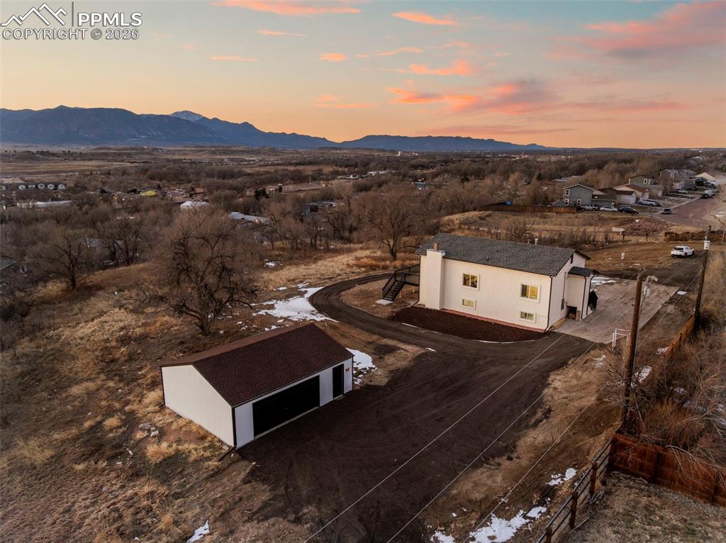 Welcome to 6801 End of the Trail, a truly one-of-a-kind property offering nearly 4 acres of agricultural-zoned land, ideal for livestock, horses, and future expansion. Positioned just west of a nearby development, this elevated and private setting delivers unobstructed, sweeping views of Pikes Peak and the Front Range across Fort Carson—views that simply cannot be replicated. Along with feeling secluded, the property is only 7 minutes from Fort Carson Gate 20 and just minutes from downtown Fountain, Fountain Creek Regional Park, I-25, and more, offering the perfect balance of convenience and seclusion.The property remains unincorporated with water/sewer while benefiting from its own high-producing well and being newly permitted and connected to city sewer, a rare and valuable combination. The land is fully fenced and gated, includes an oversized detached garage, and features a mix of mature trees and flat, usable acreage, ideal for barns, stables, workshops, or future development.Here is the best part: the home has been fully gutted and remodeled with permits, inside and out. Updates include new stucco exterior, a large composite deck designed to capture the stunning views, and complete upgrades to electrical, plumbing, and mechanical systems, along with a new well pump and upgraded electrical service. Inside, an open-concept design highlights a brand-new kitchen with stainless steel appliances, tub basin sink, and island flowing seamlessly into the dining and living areas with a walk-out slider that frames the Front Range. The renovation also added a primary bathroom and an additional half bath, enhancing both comfort and functionality.This is a truly rare offering—a serene, private Colorado retreat with breathtaking views, usable acreage, and endless possibilities, all while remaining close to Fort Carson and city amenities.