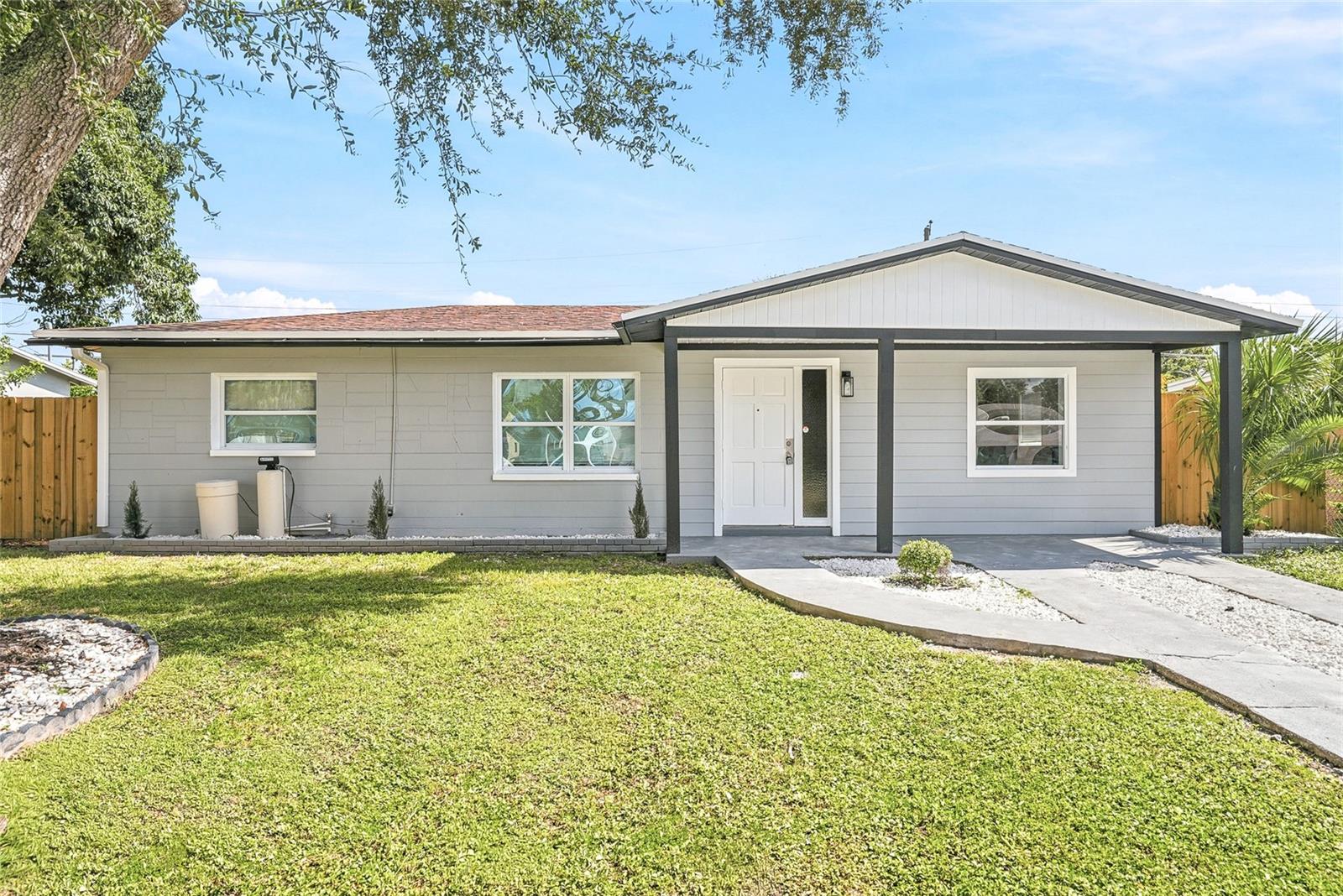 Welcome to this beautifully renovated 3-bedroom, 2-bathroom home in the heart of Pinellas Park, offering a bright, open layout, modern finishes, and plenty of natural light throughout. Luxury vinyl plank flooring flows through the main living spaces, creating a clean and cohesive feel, while sliding glass doors open to a spacious, fully fenced backyard with plenty of room for relaxing, entertaining, pets, or play. The renovated kitchen is the heart of the home, featuring quartz countertops, soft-close cabinetry, a center island for additional prep and gathering space, and four new appliances. A separate dining area provides a defined space for meals while still maintaining the open flow of the home, and a convenient indoor laundry area adds everyday functionality. The primary bedroom features a completely remodeled en suite bathroom with fresh, modern finishes, while the guest bathroom has also been beautifully updated. Out back, the patio and wood-fenced yard create a private outdoor retreat with endless possibilities. Centrally located in Pinellas Park, this home offers convenient access to shopping, dining, schools, parks, major roadways, and everyday necessities. Enjoy nearby Freedom Lake Park and Lake Seminole Park, or spend the day along the Gulf beaches of Madeira Beach and Treasure Island. With easy access to US-19, St. Pete-Clearwater International Airport, Downtown St. Petersburg, Clearwater, Tampa, and everything Pinellas County has to offer are all within easy reach, giving you the perfect combination of everyday convenience and the Florida coastal lifestyle.