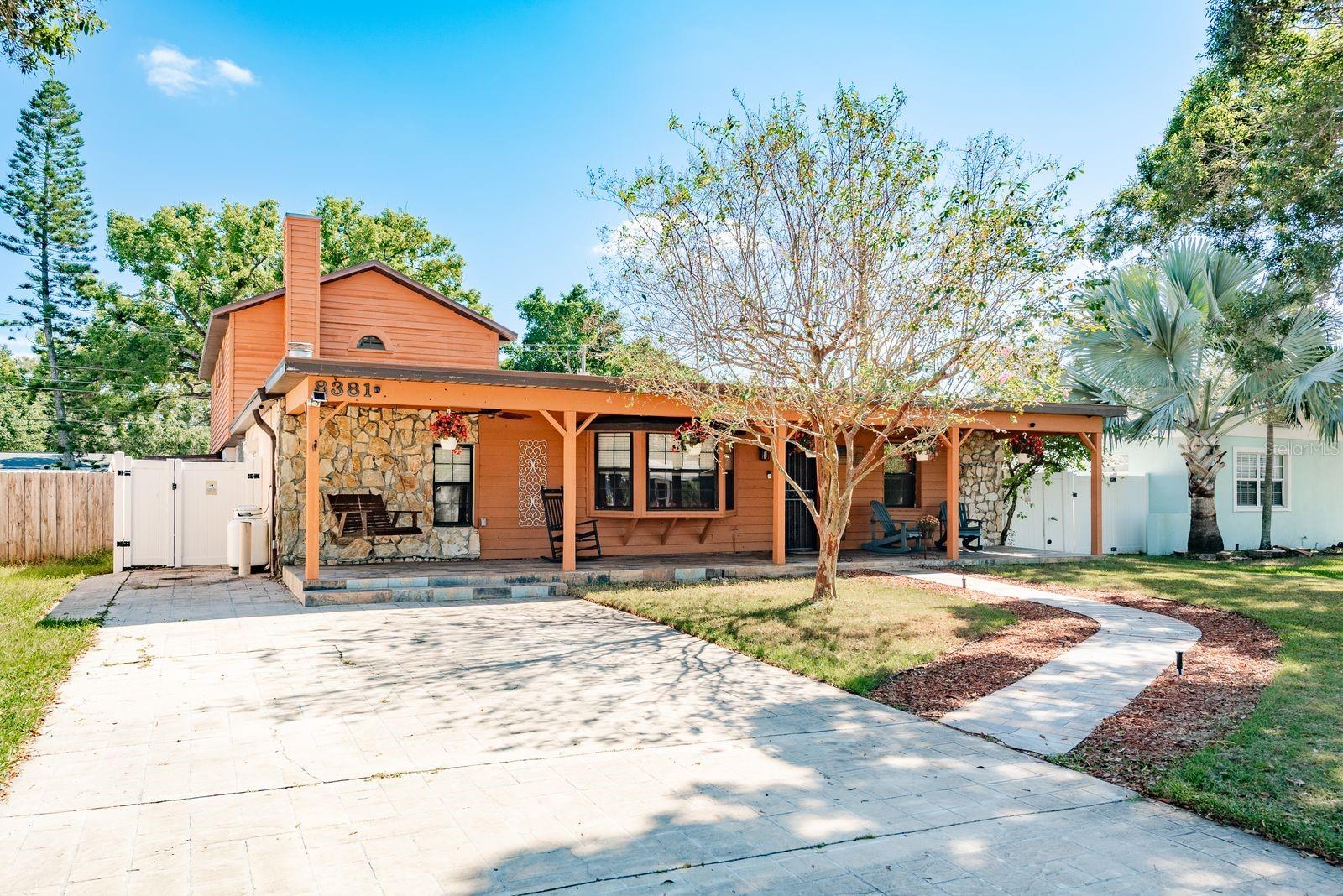 Welcome to your dream home in sunny Pinellas Park! This spacious 4-bedroom, 3-bath residence blends modern comfort with resort-style living with over 2,300 sq ft. The exterior has been freshly painted along with a brand new roof from 2025 and brand new gutters. Step inside to discover an open-concept layout filled with natural light, featuring a beautifully updated kitchen, generous living areas, and 3 bedrooms on the main floor to accommodate multi-generational living. The primary suite is your private retreat on the second floor (780 sq ft), with a fireplace complete with a spa-inspired bathroom. The shower exudes a luxurious, spa-like feel with a dramatic modern design including a built-in bench with body jets and handheld sprayer. The oversized walk-in closet is perfectly paired with built-in cabinetry for additional storage. Off of the primary bedroom, you will have direct access to an expansive rooftop patio—perfect for morning coffee or evening sunsets. Outside, the backyard is an entertainer’s paradise, boasting a giant sparkling pool surrounded by lush landscaping including fruit trees (hybrid citrus and mango) finished with pavers and a stylish concrete stamped patio and "Smart" outdoor color changing lighting near the pool. There is plenty of space for lounging or hosting gatherings. In the yard, you will also find access to the workshop (16X17)  to accommodate your storage needs or woodworking you are considering. Additional storage shed in the backyard is 12X18. (AC 2017) (Hot Water Heater 2022) (Kitchen Appliances 2022) (Gutters 2025) (Exterior Paint 2025)(Vinyl fence 2022) (Pool Pump 2024) Roll Down shutters around the home for quick protection and peace of mind in this non-flood zone. 15 minutes to Madeira beach, 20 minutes to Tampa International Airport and 20 minutes to Armature Works. Don’t miss your chance to own this one-of-a-kind property—schedule your private showing today!