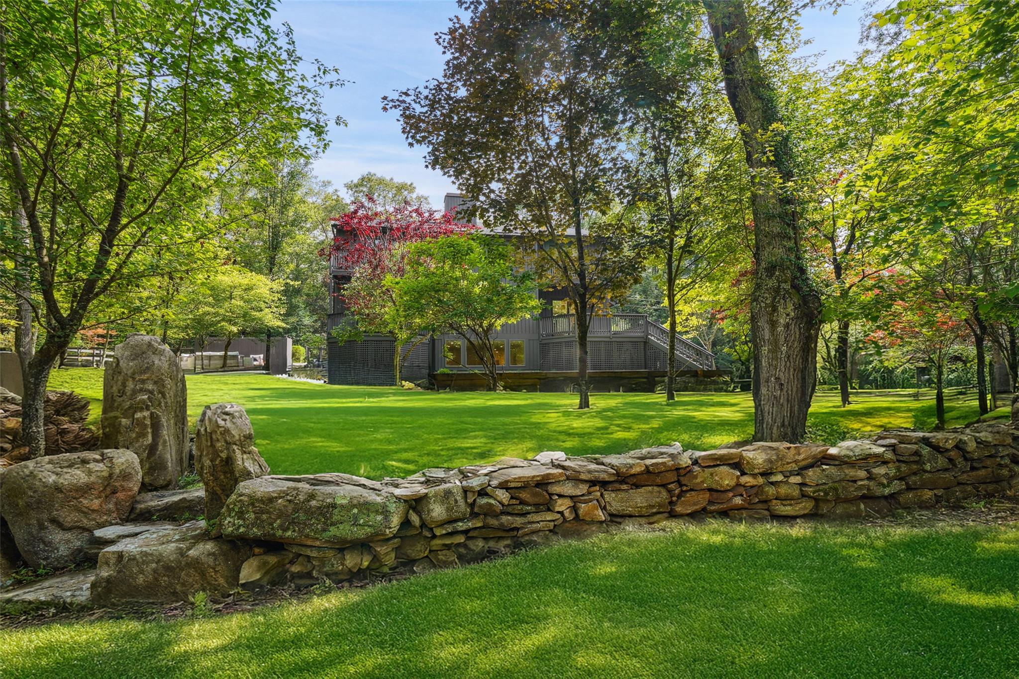 Fully renovated modern on storybook land in Pound Ridge with picturesque pond, walking trails, footbridges, natural rock outcroppings, and a gorgeous Shoreline Pool with built in spa and automatic cover. This home has a brand new designer kitchen, all new baths, new windows, flooring and roof.  The property is tucked away on a country road and enjoys complete privacy and quiet and has beautiful seasonal reservoir views from the multiple decks. All fresh, new  and ready in time for a great summer!