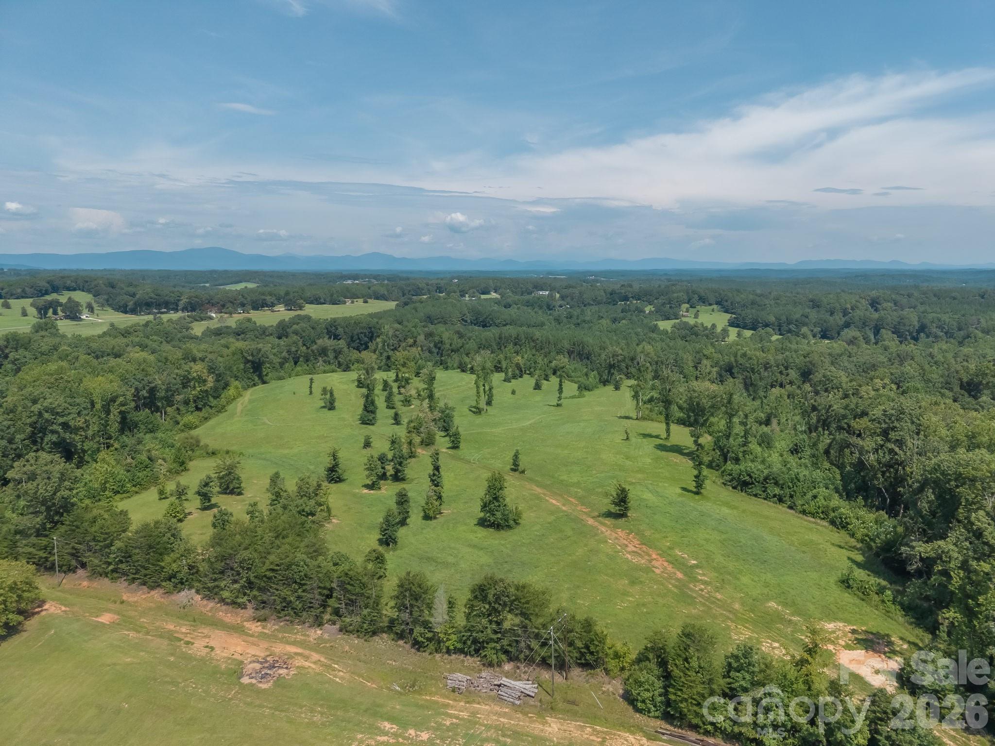 Escape to the ultimate 30-acre equestrian sanctuary and private mountain estate at 473 McEntire Rd, Tryon, NC. Perfectly suited for a premier private horse farm, expansive training facility, or multi-generational family compound, this rare parcel offers completely unrestricted acreage with absolutely NO HOA, giving you total architectural freedom in Western North Carolina’s coveted 'Thermal Belt' microclimate, known for its remarkably mild winters and cool mountain breezes.Located in scenic Polk County just 15 minutes from the world-class Tryon International Equestrian Center (TIEC), this property perfectly bridges the gap between a secluded luxury lifestyle and elite equestrian access. For out-of-state buyers looking to build, this blank canvas is uniquely development-ready: multiple level, prime build sites have been identified to perfectly position a main estate, guest cottages, or custom horse barns to maximize privacy and panoramic foothill views.