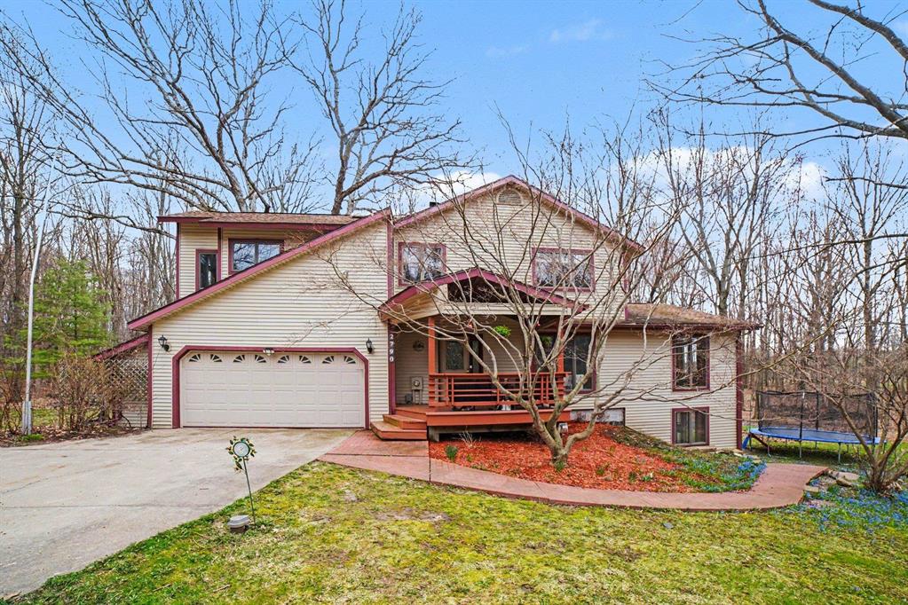 Welcome to your private retreat nestled on 15 wooded acres, this two-story gem is the epitome of country living combined with modern comfort. Upon arrival, you're greeted by the stunning beige siding with charming maroon trim, wrapped with a welcoming front porch perfect for enjoying serene sunset views. Inside, you'll find a beautifully cozy and spacious ambiance with a new central air unit installed in 2025 and furnace in 2021. The living areas boast plush seating, large arched windows allowing abundant natural light, and warm wood stove that set the tone for relaxing evenings. For culinary adventures, the kitchen offers ample cabinetry and a delightful window view. With four versatile bedrooms, each providing a snug and vibrant atmosphere, personalization comes easy. Outdoor enthusiasts will relish the abundance of wildlife and the endless exploring opportunities amidst the leafy canopies.