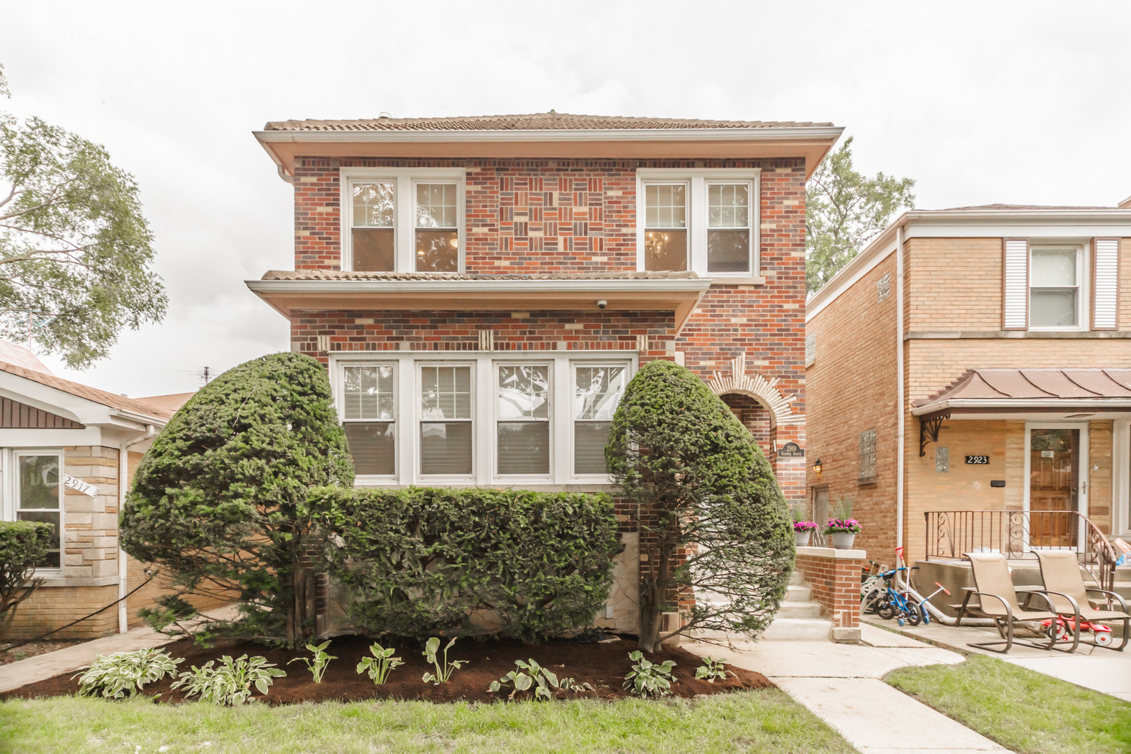 Lots of curb appeal on this English Tudor brick home, set on a quiet tree-lined street. A perfect blend of vintage charm and modern updates, this residence offers a spacious living room, a formal dining room, and a newly remodeled eat-in kitchen with quartz counters, stainless steel appliances, and updated baths. The main level includes a bedroom with en-suite full bath plus a powder room.  Upstairs you'll find four additional bedrooms, most with custom built-in closets. The remodeled lower level features a large family/rec room, yoga studio, walk-out laundry/ utility room, and abundant storage. Additional highlights include a welcoming foyer, generous room sizes, and beautifully updated bathrooms. Outdoor living shines with a large backyard and brick paver patio-ideal for entertaining. New windows installed in 2011. Centralized Space Pac A/C and radiant heat.