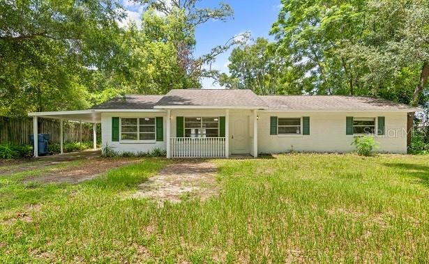 NEW LISTING | Rolling Acres Subdivision Discover this charming 3-bedroom, 2-bathroom home offering 1,296 square feet of living space. Recent updates include a new roof installed in 2023, newer windows, updated carpet (not shown in the pictures) and a new water filtration system. The home features a comfortable living room, family room, indoor laundry area, spacious enclosed back porch, and a cozy covered front porch. The eat-in kitchen includes appliances, while the primary bathroom offers a large shower and the guest bathroom has a tub/shower combination. This home needs some tender loving care, including flooring, paint, and personal updates, but it offers an excellent opportunity to restore it and make it your own. The backyard is enclosed with chain-link and white vinyl fencing, and a single-car carport is located along the side of the home. Spectrum high-speed internet is available. Conveniently located just a few miles from I-75, providing an easy commute to Tampa.