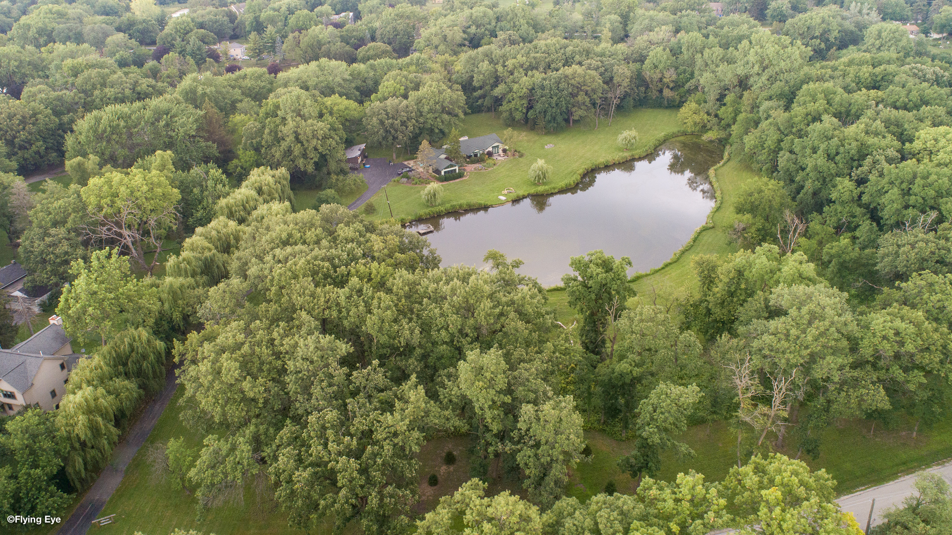 Stunning Ponderosa Estate set on 7 acres with a private pond. Two lots are being sold together: 4 acres and 3 acres. This property looks like it belongs in the pages of a luxury home magazine, featuring high-end finishes throughout. The home was completely rebuilt in 2015 and boasts gleaming hand-scraped hardwood floors. The primary bedroom feels like a vacation retreat, overlooking the pond. The en-suite bath includes a spacious step-in shower, a deep jacuzzi tub, and a walk-in closet. The chef's dream kitchen is equipped with all high-end appliances, a commercial stove/oven, a wraparound island, and a breakfast room. A stone fireplace is ideal for indoor grilling, and a huge pantry is hidden behind beautiful barn doors, leading to a large outdoor deck and fenced in dog area. The expansive living room features a large bay window with a built-in bench. The family room showcases a gorgeous stone wood-burning fireplace, complemented by custom cushions and curtains in the bay window with pond views. Formal dining area (light fixture excluded) includes a built-in dollhouse. The sun-filled laundry room offers ample counter space, built-in cabinets, and a laundry sink. A three-season room provides year-round enjoyment with wall-to-wall windows, vaulted ceilings, and a ceiling fan. The second bedroom is beautifully designed, featuring a claw-footed bathtub and shower. Every room in this spectacular home is exquisite, with water views from most windows. Horses are permitted in area. This one-of-a-kind estate has no detail overlooked. Ponderosa signifies home base or safe haven-come make this your home and explore the possibility of building another residence.