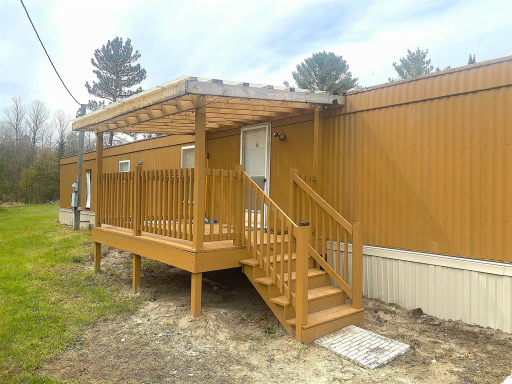 STEP INTO THE GREAT OUTDOORS! This rare opportunity offers a true slice of Pure Michigan's natural beauty. This fully updated, MANUFACTURED home features 2 spacious bedrooms, 1 full bathroom, hardwood-style flooring throughout, and reclaimed-style barnwood accent walls that deliver a warm, rustic atmosphere. Situated on 55 private acres of woods open land, the property is a nature lover's dream rich with wildlife, established trails, and two serene ponds. A 30x40 pole barn with electricity and concrete floors provides exceptional utility for equipment, storage, or hobby use. Outdoor enthusiasts will value the four custom wooden hunting blinds and the direct adjacency to acres of state land. You're also within walking distance of the renowned Au Sable River and nearby state trails perfect for fishing, boating, riding, and year-round recreation. Enjoy summer fun in the sun or winter playtime in your very own wonderland this property delivers the Michigan outdoor lifestyle at its finest.