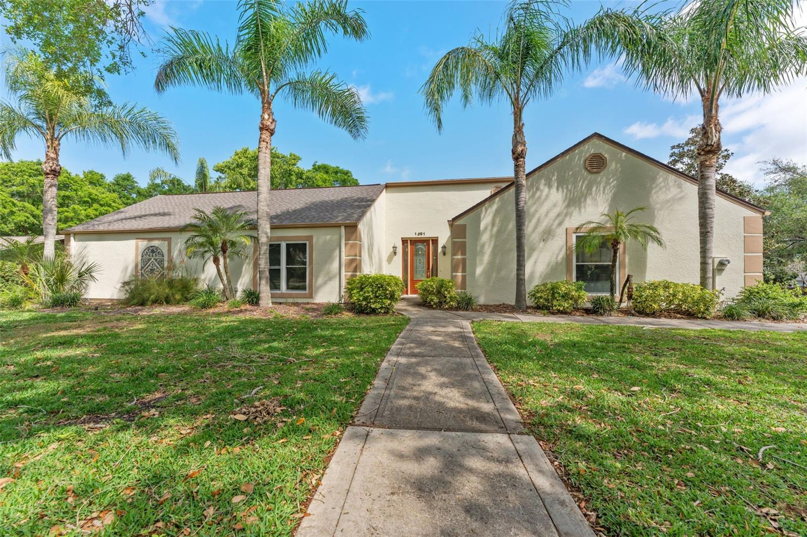Homes in this neighborhood with large lots and rolling hills do not come around often! Don't miss your chance to see this sprawling ranch style 4 BED/3 BATH home in Autumn Woods. The home was repainted entirely INSIDE & OUTSIDE, with a 2025 new roof and one 2024 new AC, Tankless water heater and hurricane impact windows! The modern CHEF'S Kitchen boasts STAINLESS STEEL appliances, gorgeous dark wood Cabinetry and GRANITE on all surfaces. The COMMERCIAL size RANGE allows you to prepare meals for even the largest family gathering. The OPEN FLOOR plan with LIVING ROOM/DINING ROOM combo allows you to socialize with your guests while spending time in the kitchen. There are a ton of cabinets for a plethora of storage! it really is a DREAM KITCHEN! Enjoy our random cool nights a little more with the wood burning fireplace in the living room. The home has such a great layout with 2 bedrooms and a bath on one side, and 2 bedrooms and 2 baths on the other, all surrounding the beautiful pool area in the backyard. The home sits on over HALF AN ACRE LOT with the backyard and pool area fenced in. The Autumn Woods subdivision offers a private park and recreation area to it's residents with basketball courts, tennis courts and even a dog park. The neighborhood features 3 lakes as well. Situated just down the street from the much sought after Palm Harbor University High School. You have beaches, parks and recreation just minutes away for the entire family. Explore quaint downtown Palm Harbor, and you're just a short drive from downtown Tarpon Springs and Clearwater. Tampa and it's airport is just 35-40 minutes away. You've got to come see this home and all that it has to offer.