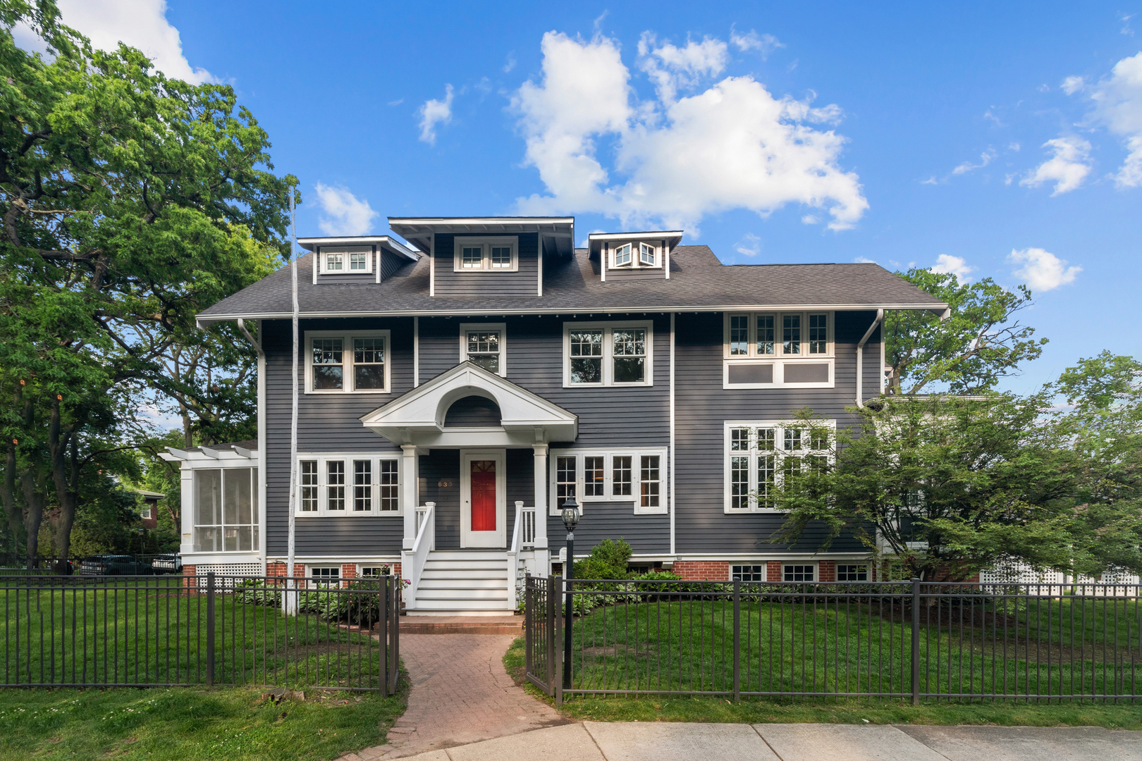 Welcome Home to East Wilmette in the ideal CAGE location just steps to Lake Michigan - this phenomenal home is perched up on a sun-filled extra-wide, corner lot with a classic center entry, over-sized rooms, impeccable flow and timeless architectural details!!  633 Elmwood features 7 bedrooms (6 bedrooms up), 5 1/2 baths with a gracious floor plan, remarkable windows & exposure and the sweetest screened porch.  Stunning oak floors, built-ins and millwork throughout will have you falling in love.  Gracious living room with a well-loved wood burning fireplace and an attached relaxing screened porch.  Spacious kitchen with a wonderful eating area adjacent to the sun-filled family room with built-in bench & stunning windows and a separate formal dining room.  5 large bedrooms on the second floor & 3 full bathrooms.  One of the second floor bedrooms is ideal for a home office.  Beautiful & private primary suite on the 3rd floor (*if desired, two options to combine two bedrooms on the second floor to easily make a primary suite and turn the 3rd floor into a home office or additional family room).  Awesome mudroom with charming built-ins that leads to the back stairwell to the 2nd floor, the side entry door to the backyard and the lower level.  An impressive lower level has a large recreational room with very high ceilings and above grade windows, a separate bedroom & full bathroom for an au-pair or in-law, second mudroom, utility room with additional laundry, storage & great walk-in pantry.  Situated on an over-sized corner lot (63 x 195).  Short walk to Elmwood Dunes, Gillson Beach & Park, Michigan Shores, Central School, the Metra & all the downtown shops & restaurants including Ballyhoo's Sophia Steak, Central Station & Pit & Tap.