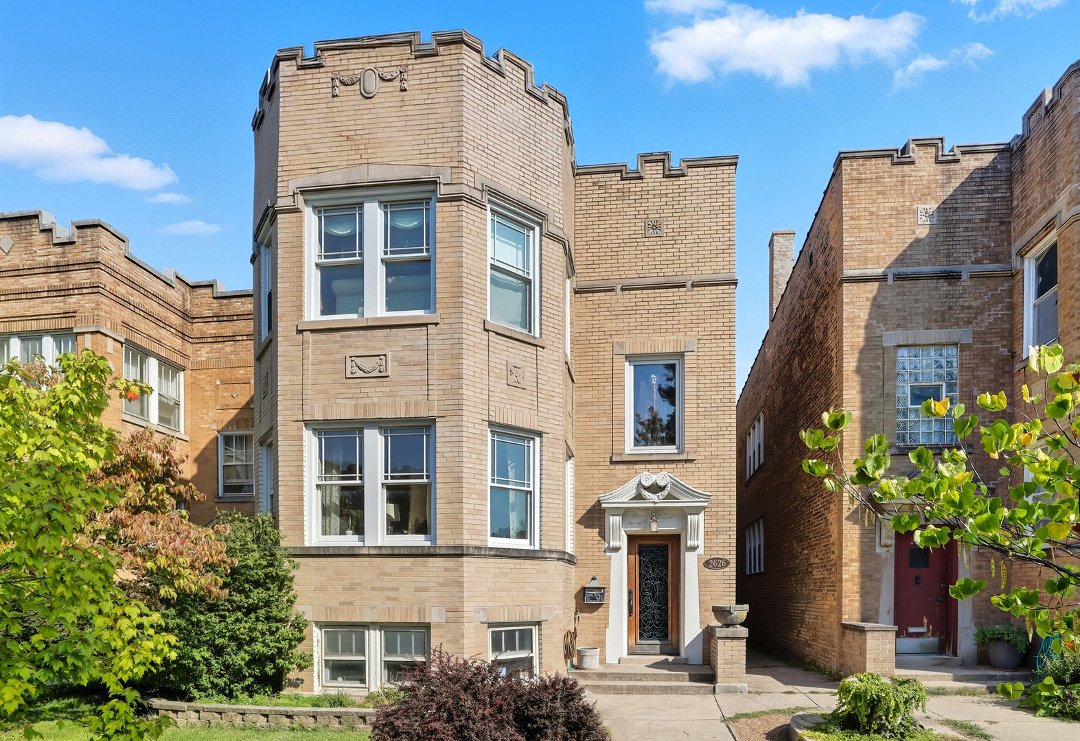 Nestled in the coveted West Ridge neighborhood, this classic Brick 3-flat at has been transformed into your own vintage-inspired retreat with 5 bedrooms and 2.5 baths, featuring a gourmet custom kitchen with chef-grade stainless steel appliances, a large quartz-topped island overlooking the back deck and adjacent to a cozy stone fireplace. Features include two fireplaces, oak hardwood floors throughout, preserved original trim and doors, a versatile first-floor family room or office, and a lower-level rec room with a full bath. The roof was replaced entirely in 2022. Enjoy the large back deck, brick-paved patio and a beautifully landscaped yard. Great location, just a half block from Indian Boundary Park, with easy access to amenities, dining, and transit, making this home a seamless blend of timeless Chicago charm and modern luxury.