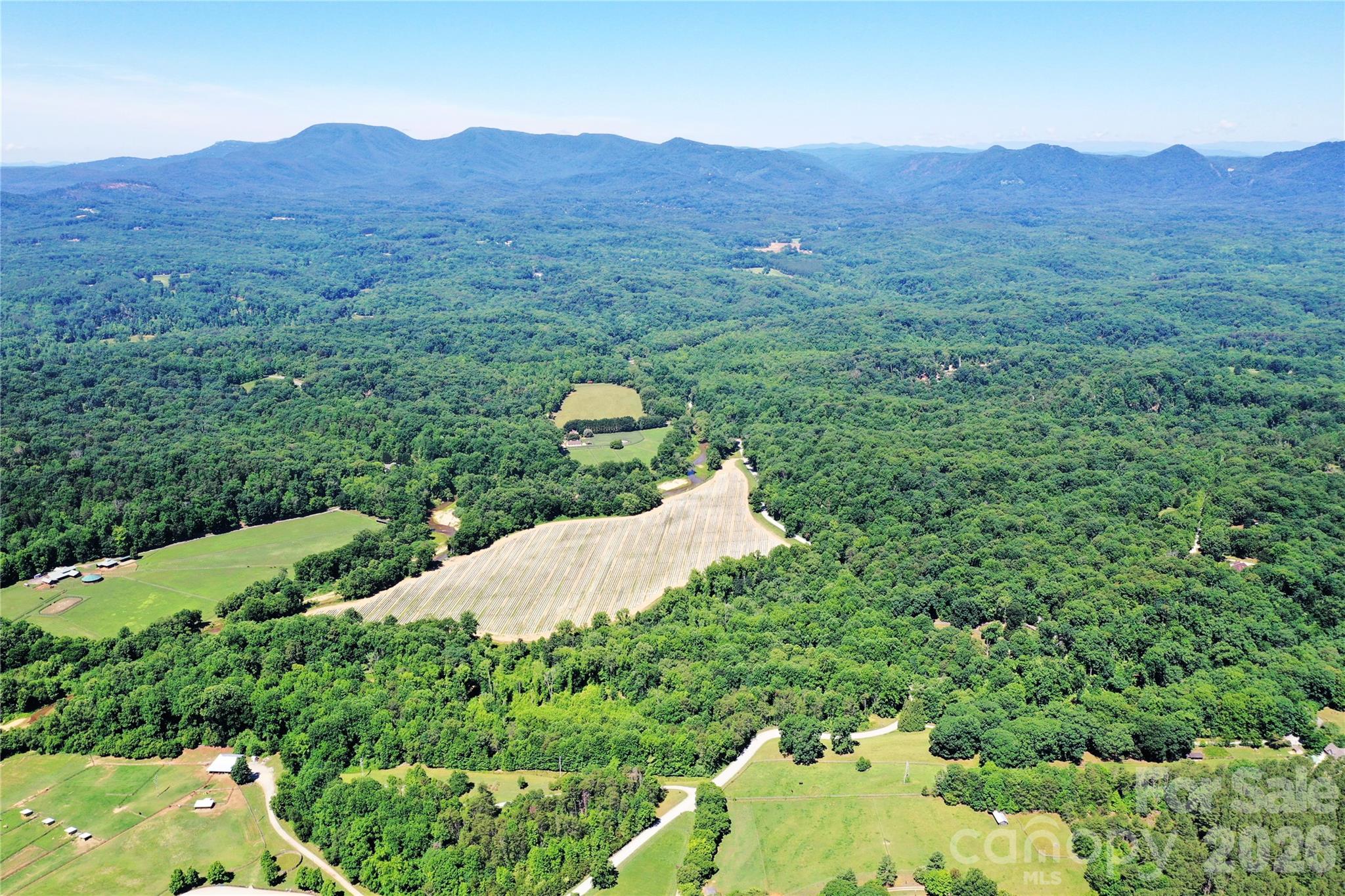 34.8+/- acres with approx.  250-300 feet of frontage on the Pacolet River - plus a creek running through it. Up top, there's a large, level, high-elevation building site with underground power already available at the approx. 1/4-mile driveway entrance. Add in access to the FETA equestrian trail system (currently closed, but reopenable by the new owner), abundant wildlife, and a mix of black walnut, river birch, cedar, sycamore, maple, persimmon and pawpaw trees.  The floodplain bottomland may qualify for a wetland/stream mitigation bank, meaning a portion of this property could generate conservation easement income instead of just sitting idle.  You've got a rare combo of homesite, investment, and conservation play just minutes from Columbus and Tryon. Only restrictions: 5-acre minimum lot size, no mobile homes.