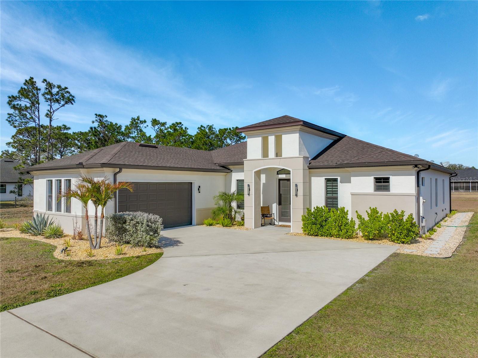 This stunning luxury residence built just five years ago and thoughtfully designed for modern living. This beautiful maintained 4 bedroom, 3 bath home with a 2 car garage sits on an expansive 1.24 acre lot, offering privacy and space.  Inside you'll find granite countertops in the kitchen and quartz counter tops in all 3 bathrooms, complemented by modernized light fixtures and high ceilings throughout the home creating a sleek and modern feel.  The open kitchen concept layout features a built in wine cooler, a pot filler over stove and a walk-in pantry that flows effortlessly into the iving areas, perfect for everyday living and entertaining.  The spacious primary suite offers a large walk-in closet while the home also includes a large walk-in laundry room with built-in cabinetry, adding convenienece and ample storage. Abundant natural light fills the home through oversized windows and additional windows to include inside the closets, bathrooms and garage.  The home is also equipped with a whole house water softener system, enduring quality water throughout. The owners have added a 22 X 25 Feet concrete slab in the backyard ready for your desired shed.  Designed for both indoor and outdoor living, the property features an Extra large covered lanai and tremendous amount of backyard space, ideal for a pool,entertaining or relaxing. Storage is abundant, with reinforced attic storage above the garage engineered to support additional weight as well as additional supportive attic storage above the primary bedroom, providing safe and practical space for all of your seasonal items. Located in the sought-after Wedgefield community, this home offers a quiet and peaceful setting where homes are spaced apart, providing privacy and a serene lifestyle. Yet it remains convenienelty close to major highways with easy access to Orlando's theme parks, shopping, dining and entertainment.