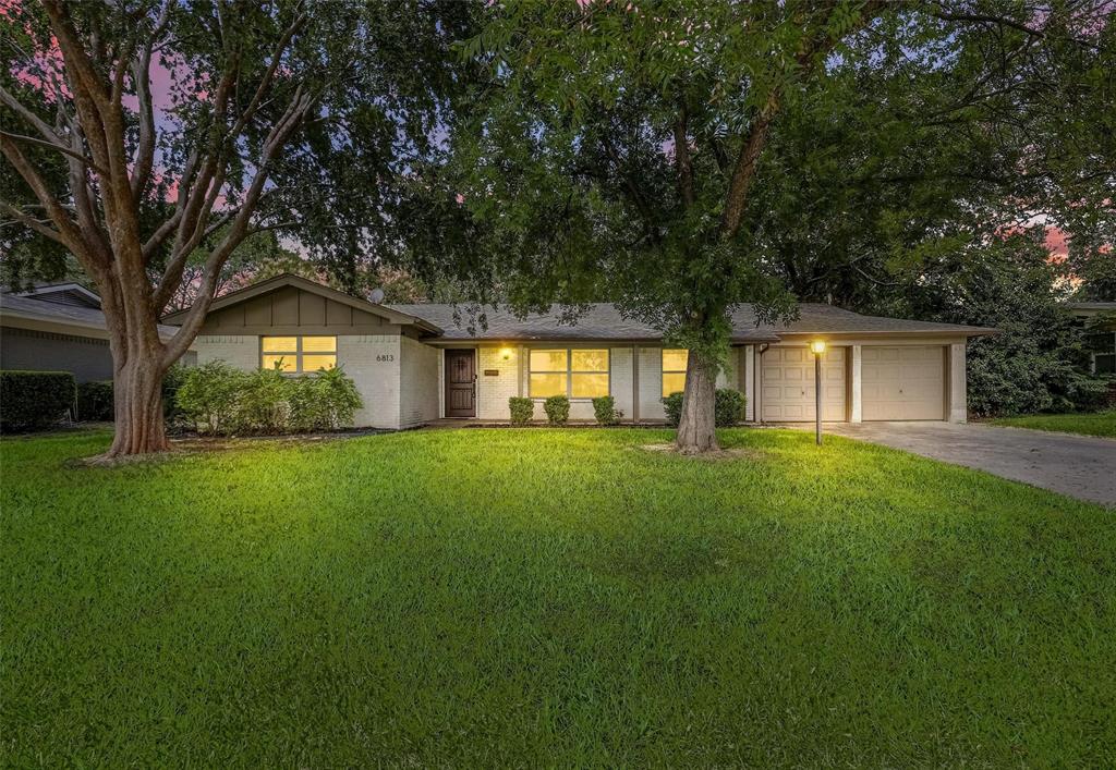 This stunning home will WOW you when you come through the front door. You will find beautiful updates spanning across a large, completely open floor plan with gorgeous hardwood floors throughout the home, living room features a brick fireplace focal point, next to glass french doors to the backyard. The kitchen has granite countertops, loaded with quality stainless steel appliances, plenty of storage space in the built-in pantries, and an open dining area next to the kitchen. The hardwood floors continue into the bedrooms which boast ceiling fans and nice closet space. Updated bathrooms feature beautiful granite countertops, beautifully tiled showers and additional storage. This home also includes updated decorative lighting, fixtures, and hardware. New water heater installed 2025, new AC unit and blower replaced a 2-3 years ago. New privacy fence installed Nov 2024. Backyard has tons of space for kids, pets, entertaining or a pool. The back porch is highlighted by hanging edison lights powered by solar, a firepit and plenty of space for seating, grilling and more. No neighbors across the street. Large green space is your view across the street.