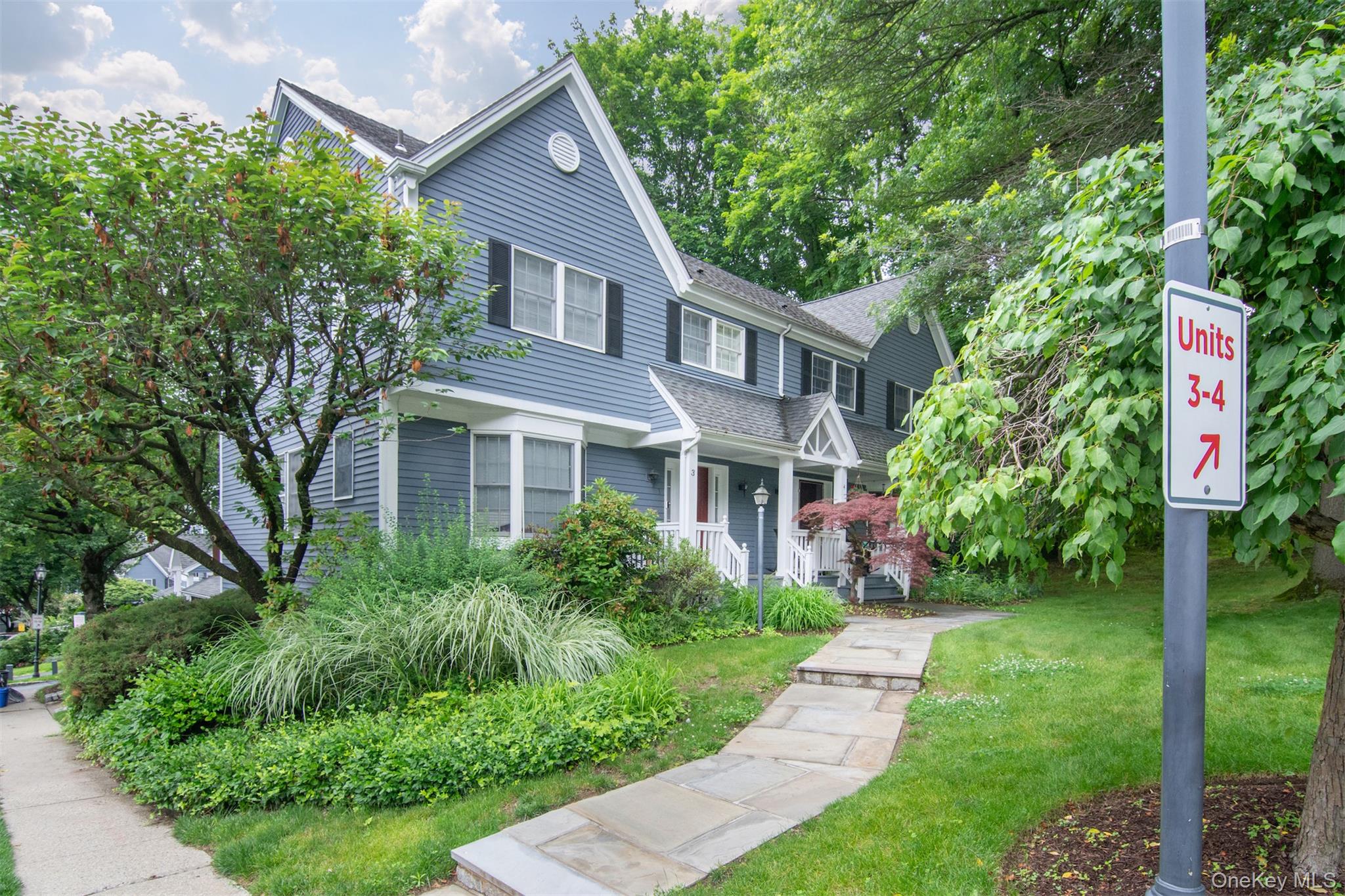 Experience the vibrancy and user-friendly vibe of the Hamlet of Chappaqua in this very special move-in ready, end-unit townhouse, which could be the one you’ve been waiting for. Perfectly located, it is walkable to train, schools, restaurants, shops, farmer’s market, town hall, library and more. It offers generous space with flexibility of use featuring two large bedrooms, plus loft, lower level flex room and 2 1/2 baths.  There are fabulous hardwood floors on both the first and second levels -- oak with cherry stain on the first and beech wood on the second.  After entering through a rocking chair, covered front porch, the main floor features a considerable entry hall, powder room, renovated dine-in kitchen with bay window and pantry, newer stainless steel appliances, and new silestone counters and backsplash. The expansive, sun-filled dining area flows seamlessly into the living room, showcasing  an elegant wood burning fireplace and custom built-in shelving. A sliding glass door leads to a private deck. The second floor has a sizable primary suite with great closet space and a nicely updated bath. The second bedroom is very spacious. A large loft area is currently used as an office but could be used as a media or guest space depending on your needs. A modern hall bath completes the second floor. The basement offers an additional 531 square feet (not included in the 1767 total square footage). This area features a flex room, a huge laundry room, amazing storage space and access to the garage. Leafy front and side yards with two gardens of eco-friendly native plants and designated as "pollinator pathway" are unique to this unit. One car garage plus two additional parking spaces (driveway and carport) are also unique to this unit. This townhouse is truly a “must see.” It is no wonder that this was the builder’s model!