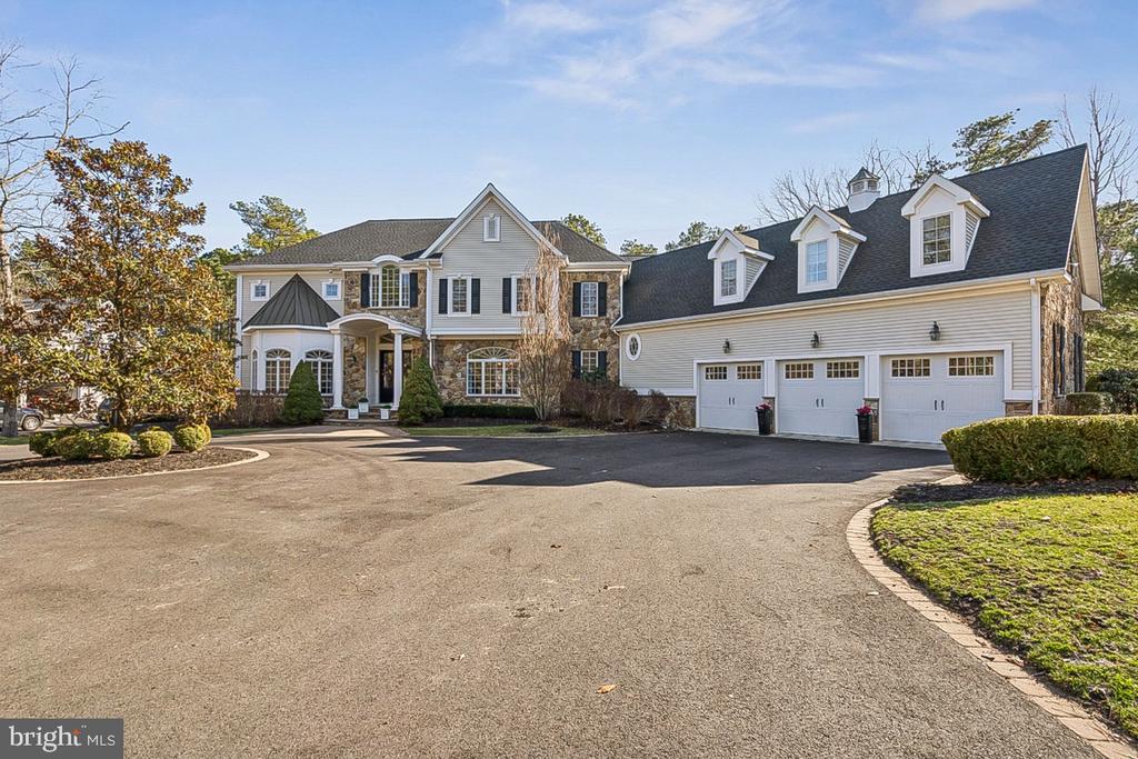 Custom built by renowned builder Gary Gardner, this exceptional 6,095 sq ft executive home offers timeless design, quality construction, and an unmatched private setting. Owned by only its second owner, the home showcases beautiful curb appeal with a circular driveway (new blacktop 2024) and meticulous upkeep throughout.A grand front-to-back foyer creates a bright and elegant first impression, complemented by dual staircases for both formal and functional flow. Radiant heated floors extend throughout the entire first floor, as well as the second-floor bathrooms, laundry room, and garage. Designed for entertaining and everyday living, the family room features a fireplace and wet bar, while the gourmet kitchen includes Sub-Zero refrigerator and freezer, Dacor appliances, and two Bosch dishwashers, along with a butler’s pantry.The home offers 5 full baths and 2 half baths, including a luxurious primary suite with fireplace and newly renovated spa bath (2023). Additional accommodations include a private guest suite, two bedrooms with a Jack & Jill bath, and an additional en-suite bedroom with walk-in closet.Outdoor living is exceptional, backing to private Arrow Lake (only five homes) with a private trail to the water, plus access to additional lakes, trails, and a residents-only beach. Enjoy a Trex deck (2023), basketball court, and a fully renovated pool with new equipment (2024–2025), surrounded by privacy landscaping.The expansive basement offers a gym area, storage, HVAC space, half bath, and access from both the garage and main foyer.Additional features include 5-zone HVAC with 3 new AC units (2021, 2024, 2025), two 200-amp panels, twin water heaters, whole-house surge protection, Sonos sound system, EV charger, new roof (2023), septic pump (2021), Speed Queen washer/dryer (2023), new carpeting (2024), custom closet (2025), and more.A rare opportunity to own a private lakeside estate offering luxury, comfort, and lifestyle.
