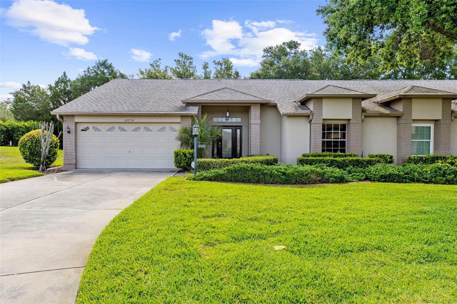 One or more photo(s) has been virtually staged. DESIRABLE END UNIT in the active 55+ , gated private  golf community of  Heritage Pines.
 Looking for an active community !!! Low HOA fee covers cable, internet, exterior maintenance, lawn care, irrigation and exterior painting.  ,fitness center, heated pool and spa, tennis, crafting, woodworking, pickleball and more.
This 2 bedroom 2 bath end unit has a premier walk in shower in primary bath and a walk in tub in 2nd bath. AC installed in 2024.The sun room has been enclosed with new windows and opens up to living and dining area adding a larger open feel. No rear neighbors makes for lots of privacy on your back patio, Inside laundry off kitchen and garage with cabinets and counter space for folding.