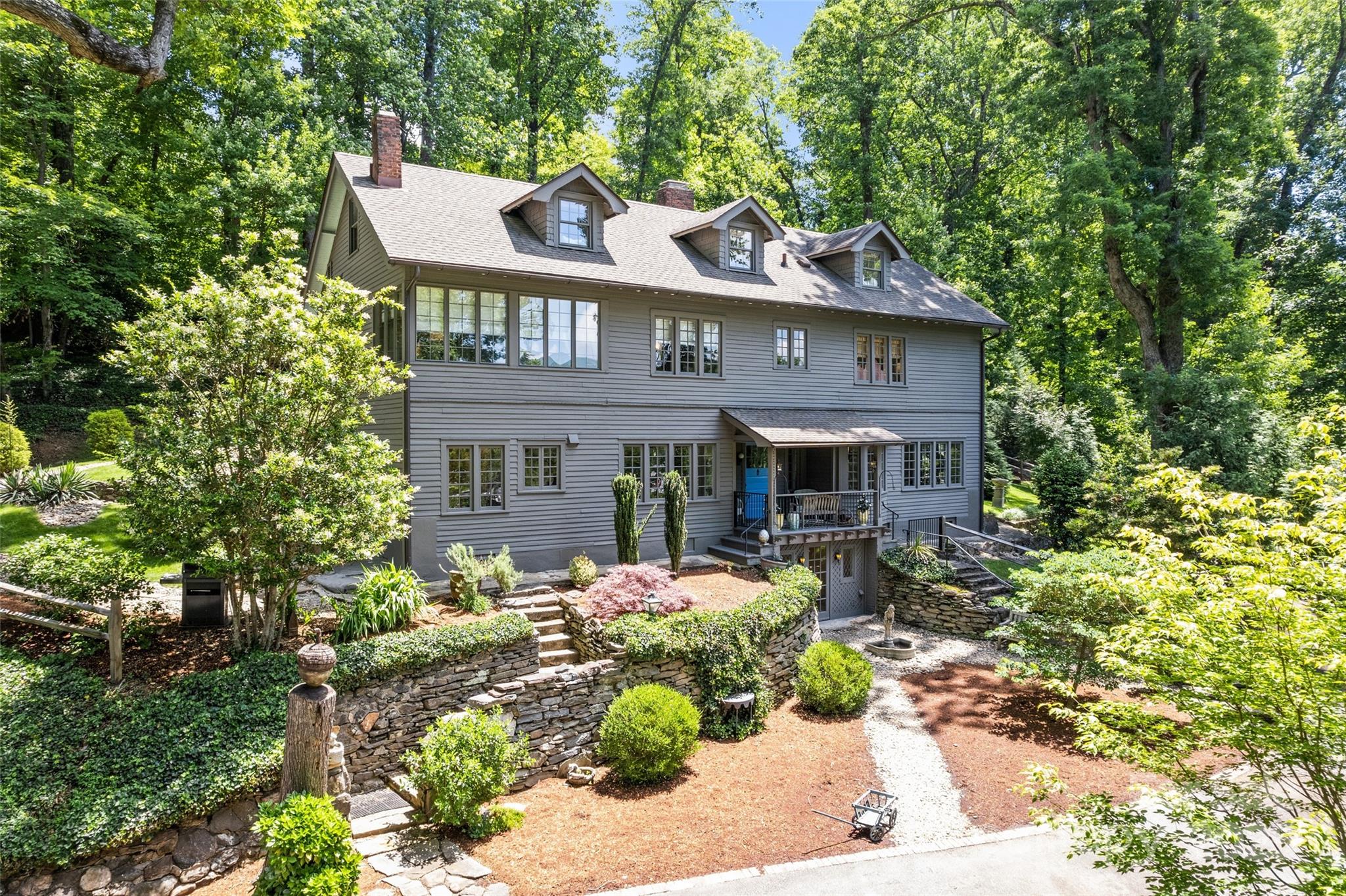 Nestled atop a scenic ridge, this rare downtown find is a just a short stroll from the town of Tryon, Mostly Hall blends historic charm with modern luxury. This immaculate 5 bedroom, 4.5 bath home boasts winter mountain views, marble kitchen and baths, original hardwood floors, and high ceilings. Ideal for entertaining, enjoy a basement wine room and a versatile converted garage.   Mature landscaping and stonework on 1.07 acres surround the property, while a separate apartment offers income potential or guest space. Once home to Emma Payne Erskine, a key figure in Tryon’s history, Mostly Hall offers rare privacy and proximity to Landrum, Columbus, and the Tryon International Equestrian Center. Experience timeless elegance and contemporary comfort in this exceptional residence.