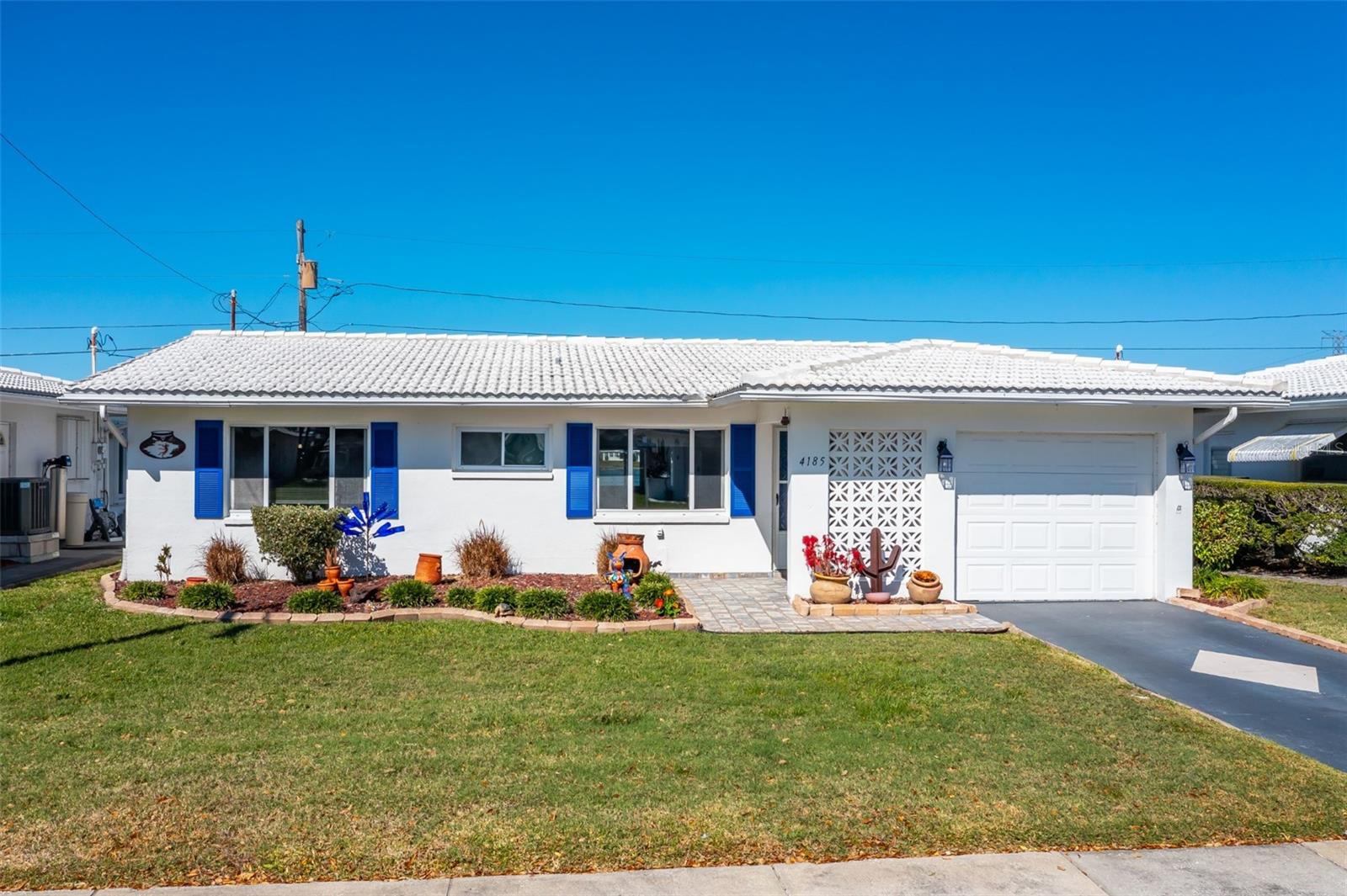 Your slice of Waterfront Paradise:  Experience the ultimate Florida lifestyle in this rare, water-view Drayton model nestled in the highly sought-after Mainlands of Tamarac by the Gulf Unit 2. This vibrant 55+ golf community offers a perfect blend of tranquility and activity, where your morning coffee comes with peaceful lake vistas and golden-hour breezes.LUXURY UPDATES FOR PEACE OF MIND:This meticulously maintained 2-bedroom, 2-bath home has been transformed with modern finishes and major updates:Brand New Roof (2025) & New HVAC (2026) for years of worry-free living.Stunning New Luxury Vinyl Flooring (2025) throughout for a seamless, modern coastal feel.Fully Updated Kitchen (2025) and both Bathrooms Renovated (2024) with tasteful contemporary finishes.New Lighting & Ceiling Fans (2025) to keep your sun-drenched spaces cool and bright.WATERFRONT LIVING AT ITS BEST:Step into 1,328 sq ft of heated living space designed to maximize your views. The open floor plan flows effortlessly toward the water, offering a serene backdrop for entertaining or quiet relaxation. Outside, enjoy beautifully landscaped grounds just steps away from the community clubhouse, heated pool, and the 18-hole professional golf course.COMMUNITY HIGHLIGHTS:Active 55+ Lifestyle: Full social calendar, shuffleboard, and private paved streets.Maintenance-Free Convenience: Low $455/month fee covers lawn care, exterior painting, irrigation, cable, internet/wifi, water/sewer/trash.  Prime Location: Centrally located: Minutes from Pinellas County’s famous white-sand beaches, airports, interstates, dining and shopping.Pet Friendly: Bring your furry companions to this welcoming tropical paradise.Don't just buy a home—buy the Florida dream. This move-in-ready gem offers the rare combination of recent major updates and prime waterfront positioning.Schedule your private showing today and start living the life you’ve earned!