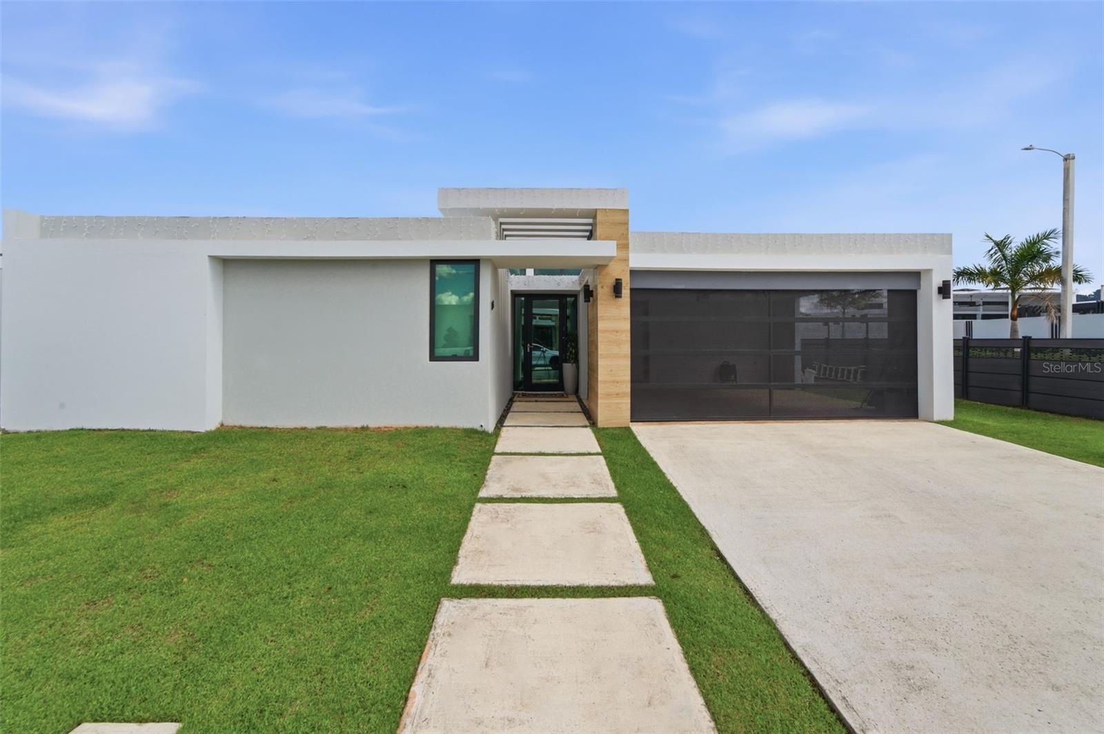 Step into the perfect blend of modern design, everyday comfort, and peace of mind with this recently built, single-level corner home on a 510 sq. meter lot, ideally positioned at one of the best streets in the desirable Residences at Río community. Enjoy quick access to top private schools while living with the security and lifestyle you want, including 24/7 gated security, a resort-style pool, fully equipped gym, and sports courts.Designed for efficiency and resilience, the property features solar panels paired with two Tesla Powerwall batteries, delivering reliable backup power and added energy savings. Inside, you’ll find 1,960 sq. ft. of living area with a functional layout that flows beautifully: 4 bedrooms, 3.5 bathrooms, a spacious kitchen, open-concept living and dining areas, a dedicated laundry room, and excellent storage.Move-in ready and well cared for, the sale includes brand-new appliances, window curtains, and more. A spacious storage area next to the garage provides room for all your essentials.This is a rare opportunity to own a modern, secure, energy-smart home in one of Bayamón’s most sought-after neighborhoods. Contact us today to schedule your private showing.