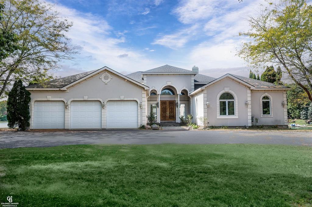 Beautiful contemporary home on Lake Angela - breathtaking views - a chef's kitchen with granite counters, gas fireplace, double ovens, built-in cook top, microwave, sub zero refrigerator, multiple prep areas, dishwasher, deep fryer, cabinets have Swarovski crystal knobs, office off of kitchen overlooking water - great room opens to 1,000+ square foot deck with inlay design - primary bedroom has gas fireplace, beautiful views, access to deck and 2 walk in closets, one has a cedar closet within - primary bath has double sinks, walk in shower, private toilet & bidet - second bath has double sinks - first floor laundry has sink, dog wash and built in ironing board - lower level has 3 door walls to 1,900+ square foot deck built over the lake plus large cedar closet, tornado shelter, 2 furnaces, 2 hot water heaters, a room prepped for bath - heated 3 car garage - circle drive - association fee covers maintenance of streets, lake and common areas