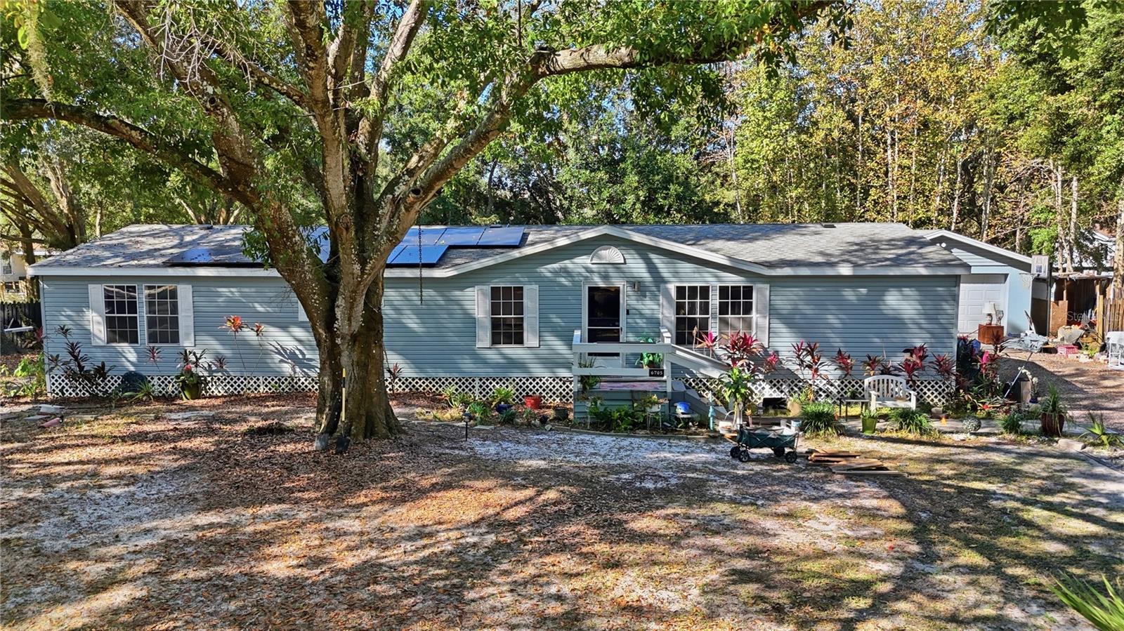 Welcome to your next great investment or perfect first home! This beautifully maintained Wesley Chapel property offers modern efficiency and long-term savings with 32 solar panels (11.75 kW total) — 12 in the front and 20 in the back. Keeping energy costs low year-round. Major systems are already updated for peace of mind: roof, A/C, and water heater all replaced in 2020! The property also features two septic systems, offering extra flexibility and functionality. Enjoy a spacious lot of half an acre with room to grow, rent, or simply relax in the Florida sunshine. Conveniently located near top-rated schools, shopping, and major highways with gated entrance, fully fenced lot and no HOA, this home combines smart living with great value. Don’t miss this opportunity to own an energy-efficient home with tons of potential!