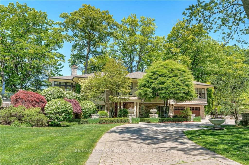 A rare opportunity to own an 8 Acre estate property in Downtown Waterdown. Custom designed raised Bungalow tailored for elegant easy living & entertaining. 2+1 Bed, 3.5 Bath Residence plus Guest House, Studio/Workshop building & separate One Bedroom Cottage. The Comfort & Beauty of a Southern style home is unmistakable upon entry into the elegant Foyer w/heated marble floors. Enjoy Panoramic Vistas from every window & timeless custom detailed interiors. Quarter Sawn Oak Floors,10' Ceilings, 9' Interior Doors, Heated Stone Floors, solid Oak staircase & much more! Charming Farmhouse Kitchen with oversized marble island, luxe s/s appliances open concept to a spacious Family Room w/Fireplace & Forested views. Exquisite French Door walk-out to All Season Room with heated floors, floor to ceiling windows overlooking ravine & walk-out to 840 s.f. raised IPE wood Deck. Elegant Dining Room with breathtaking views. Gracious Living Room with custom gas Fireplace & pocket doors to Den. Main Suite is a luxurious sanctuary with elegant walk-in wardrobe, lavish 5pc Ensuite & walk-out to private Terrace. Private 2nd Bedroom w/3 pc. ensuite. Above grade Lower Level w/full in-law Suite featuring Family/Media Room with Fireplace, Kitchen, Bedroom & 4pc Bath. Heated Drive, Entry Gate w/intercom, Camera Security System, Generator, Landscape Lighting & more! Property Severance potential. Steps to shops, restaurants & the Bruce Trail. Minutes to Schools, Parks, main HWY's & GO Stn.
