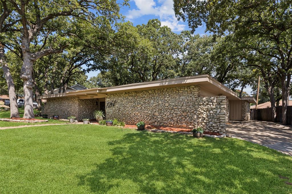This 1966 mid-century modern home is a perfect example of the genre, characterized by a single story, flat roof, rock façade, extensive use of terrazzo, and clean lines. Set in the leafy Ryanwood neighborhood in East Fort Worth with easy access to Fort Worth, Arlington, and Dallas. The home features a large primary bedroom, two secondary bedrooms, a dining room with a fireplace, and a spacious living room with a second fireplace. 

New HVAC, flooring, dishwasher, refrigerator, disposal and interior and exterior paint were added in August 2025.