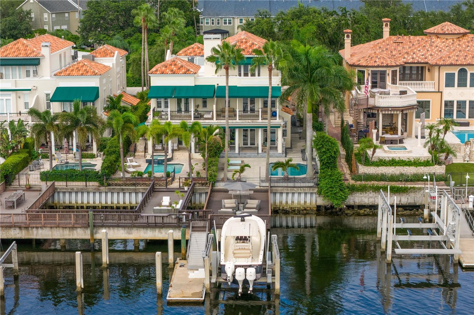 Welcome home to the pinnacle of casual sophistication on Harbour Island, where a completely redesigned three-level waterfront residence redefines luxury living in Tampa Bay. Framed by the artistry of SOL Design Architecture, this home greets you with a front entry hallway that effortlessly unfolds into a luminous great room. Towering windows capture daily sunsets over the water, while seamless sightlines invite the outdoors in, setting the stage for both intimate evenings and grand gatherings.  Step into the chef’s kitchen, where Wolf and Sub-Zero appliances stand ready beneath custom millwork and expansive storage. The great room flows to a cantilevered deck suspended above the water and adds an additional nearly 600 sf of outdoor living, complete with a private pool, spa, covered lanai, and built-in Wolfe outdoor kitchen. Whether you’re hosting sunset cocktails or slipping into your boat for a day on the water, every moment here feels both private and jubilant.  On the first floor, discover a versatile bedroom suite—ideal as a guest retreat, home office, or private workout studio—with its own ensuite bath. A solid steel and wood floating staircase sweeps you upward to a dedicated media and game room, where a wet bar and second-floor balcony offer panoramic water vistas. Two additional bedrooms share a nicely appointed full bath with double vanities and oversized tub and shower with chic finishes and beautiful pendant lights.  Ascend to the third floor and enter an entire wing devoted to the primary suite, a five-star sanctuary overlooking the glistening waters. The spa-inspired bathroom flows directly into the bedroom, delivering uninterrupted water views from the oversized soaking tub to the glass doors. An adjacent custom closet provides an abundance of storage, ensuring that form and function unite in perfect harmony.  The location of this residence is superior to others within the neighborhood providing exceptional privacy and expansive views, unlike others in the neighborhood, as it abuts the prestigious Pointe neighborhood.   Harbour Island’s 24-hour guarded gates ensure serenity, yet you’re mere steps from Tampa’s vibrant Riverwalk, Bayshore Boulevard, Water Street, and the city’s premier arts and dining districts. Commuters appreciate quick access to I-275, the Lee Roy Selmon Expressway, and Tampa International Airport, making every aspect of daily life effortless.  Move right in and begin living the waterfront dream you’ve always imagined—sunsets, sailing, and sophisticated entertaining await.