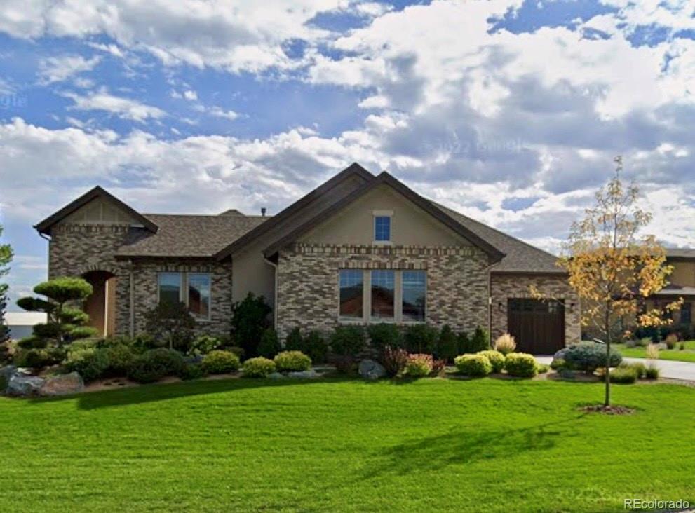 On a quiet cul-de-sac in the prestigious neighborhood of Red Hawk Estates, this beautifully crafted Colorado home welcomes you with a distinctive covered entry that opens to a private front courtyard, setting the tone for the warmth and character found throughout. Inside, soaring ceilings, abundant natural light, rich woodwork, and a three-sided fireplace define the open living spaces, which seamlessly extend to the covered back patio for effortless indoor-outdoor living and entertaining.At the heart of the home, the chef's kitchen is beautifully appointed with GE Monogram appliances, including a six-burner gas cooktop, double ovens, convection oven, warming drawer, wine cooler, extensive cabinetry, a pantry, and a spacious eat-in dining area. A formal dining room, flexible front office or fifth bedroom, and thoughtfully designed floor plan offer exceptional versatility. Upstairs, the primary suite featuring a spa-inspired shower, jetted soaking tub, and generous walk-in closet, while two secondary bedrooms on the main level share a Jack-and-Jill bath.The partially finished lower level expands the living space with a guest suite, wet bar, and endless possibilities for recreation and entertaining.Outside, professionally designed landscaping transforms the backyard into a true Colorado oasis. A covered patio, dramatic stone fire feature, tranquil water feature, and lush mature landscaping create an extraordinary outdoor living experience that feels both private and unforgettable. Complete with an Owens Corning lifetime laminated fiberglass roof, this exceptional residence offers timeless design, quality craftsmanship, and an unmatched setting in one of Broomfield's most desirable neighborhoods.
