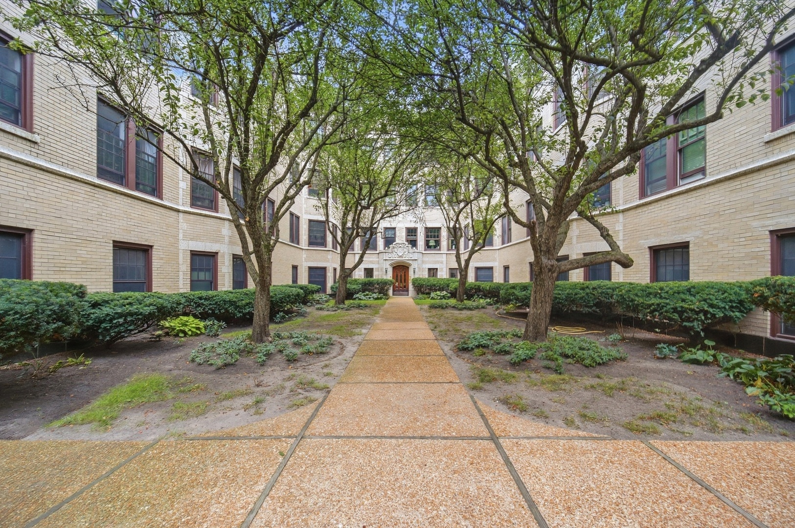 Look. No. Further.  This updated classic has everything you are looking for.  Walk to transportation, shops, restaurants, school and more.  This high first floor, in Stoneleigh Castle, has courtyard views from the living room and great all around exposure and light from the many large (new) windows.  (No brick wall views here- surrounding buildings are set back from this tier.)  Enjoy vintage wood floors, wood burning fireplace, barrel vaulted gallery entrance & crown moldings.  Light, neutral decor throughout, coupled with beautifully updated bathrooms- one with a jetted tub and one with an oversized shower, redone white/stainless kitchen with butler's pantry, in-unit laundry, energy efficient windows and new back door provide all of the 21st century conveniences you could want.  Street parking, Evanston lots (wait list), bus, "L" and Metra are all nearby. Brothers K Coffeehouse, Lucky Platter, The Alcove, Hoosier Momma Pie are outside you door- Whole Foods, Walgreens, Starbucks too!