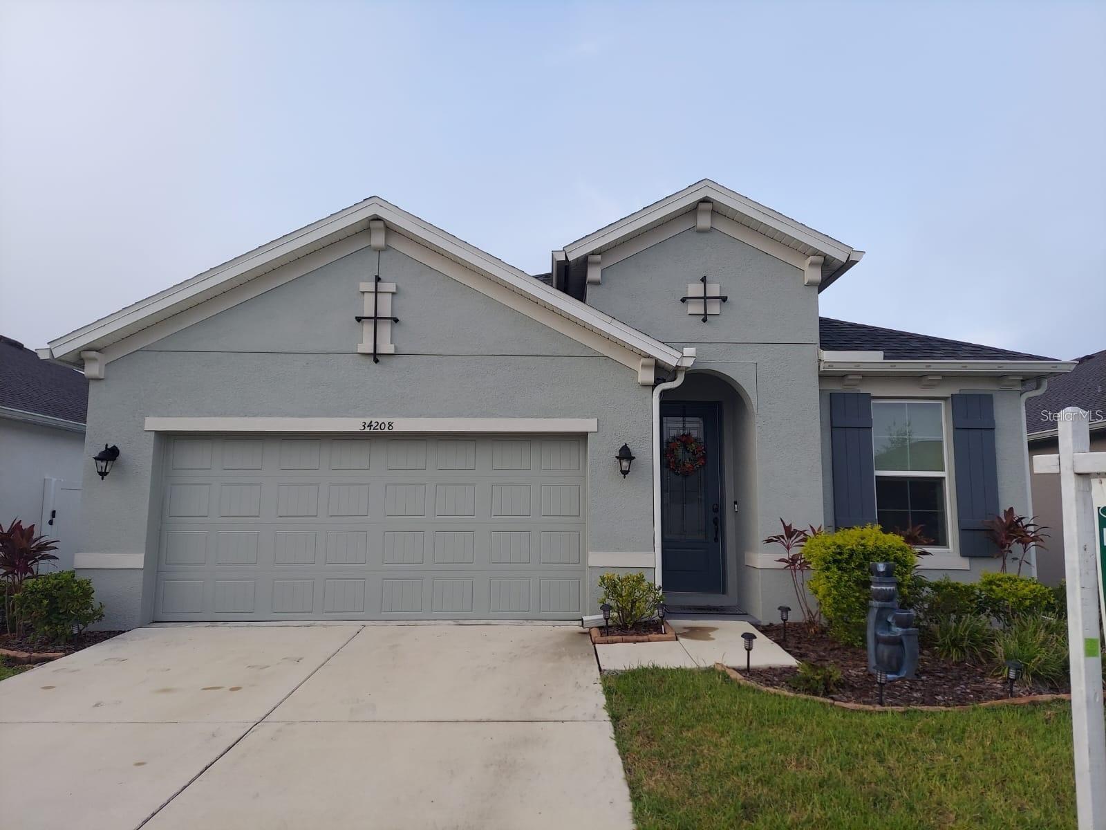 Welcome to your dream home in the charming community of Wesley Chapel. A standout feature of this home is its fully paid-off, owned solar panel system: no lease, no monthly solar payment, and no loan to assume. The new owner gets the benefit of lower energy bills from day one. The home is minutes from shopping, dining, Publix, AdventHealth, The Shops at Wiregrass, Tampa Premium Outlets, and I-75 for an easy commute to Tampa.  Built-in 2022, Beautiful finishes and high-end features define a move-in-ready residence: this 4 Bedroom 2 Bathroom and 2 Car Garage. The Redwood by Inland Homes is a modern open floor plan. You will love the chef’s kitchen with upgraded Quartz countertops, Stainless steel appliances, a floating range hood with tiled backsplash, a pantry, and gorgeous 42" cabinets. Enjoy the sun and sunsets in your spacious backyard! Extended upgrade in pavers next to a garden with enough land to plant your preferred trees. The home also has upgraded lighting, a laundry room with additional storage, and a utility sink. Watergrass Elementary School is inside a neighborhood, Brand New Charter Schools right outside of the neighborhood have Excellent locations, close to Great Schools, Pasco Hernando Jr College, Saint Leo University, AdventHealth Hospitals, BayCare Hospital, Florida Medical Clinic, Wire Grass Mall There is a basketball court and playground under 1/4 mile from your front door. There is an additional dog park, and 3 community pools. Your new home is right down the road from one of only a few world-famous Crystal lagoons. Enjoy acres of emerald blue water, sand beaches, paddle boarding, slides, restaurants, bars, etc. Wesley Chapel is the newest hot growth area, just 30 min north of Tampa. The exclusive Watergrass community is 5-10 minutes from schools, shopping, dining, outlet mall, movie theater, ice skating, etc. And just under an hour to downtown Tampa and Tampa International Airport.