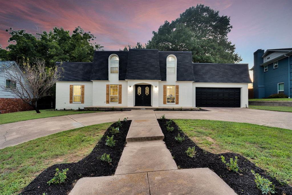 A home that is as breathtaking as it is functional, this French country inspired masterpiece is truly one to show off. From the moment you arrive, the circle drive, manicured curb appeal, and timeless French country exterior set the stage for a property that feels both elegant and inviting.

Step inside to a French country and modern interior where every detail has been thoughtfully designed. Soaring cedar beams frame the open-concept living space, anchored by a magnificent stone fireplace that radiates warmth and charm. The chef’s kitchen is a work of art with Calcutta countertops that flow seamlessly into the cabinetry, creating a stunning focal point for entertaining and everyday living.

Every bathroom has been finished with the same luxurious countertops, while the primary bath is a true retreat.. featuring a large custom shower and gorgeous hexagon tile flooring that combine beauty and sophistication. The primary suite is privately located downstairs, with the remaining bedrooms upstairs, including a versatile 4th bedroom that can transform into an office, game room, or media space.

Outdoors, the property is just as enchanting. A creek runs along the back of the lot, offering the opportunity to design a one-of-a-kind stairwell or deck leading down to the water—perfect for evening gatherings, quiet mornings, or showcasing the natural beauty surrounding your home.

With a brand-new roof and new AC condenser, this property pairs style with peace of mind. 4220 Dawn Dr isn’t just a home.. it’s a statement of beauty, comfort, and timeless design in one of Benbrook’s most desirable neighborhoods.