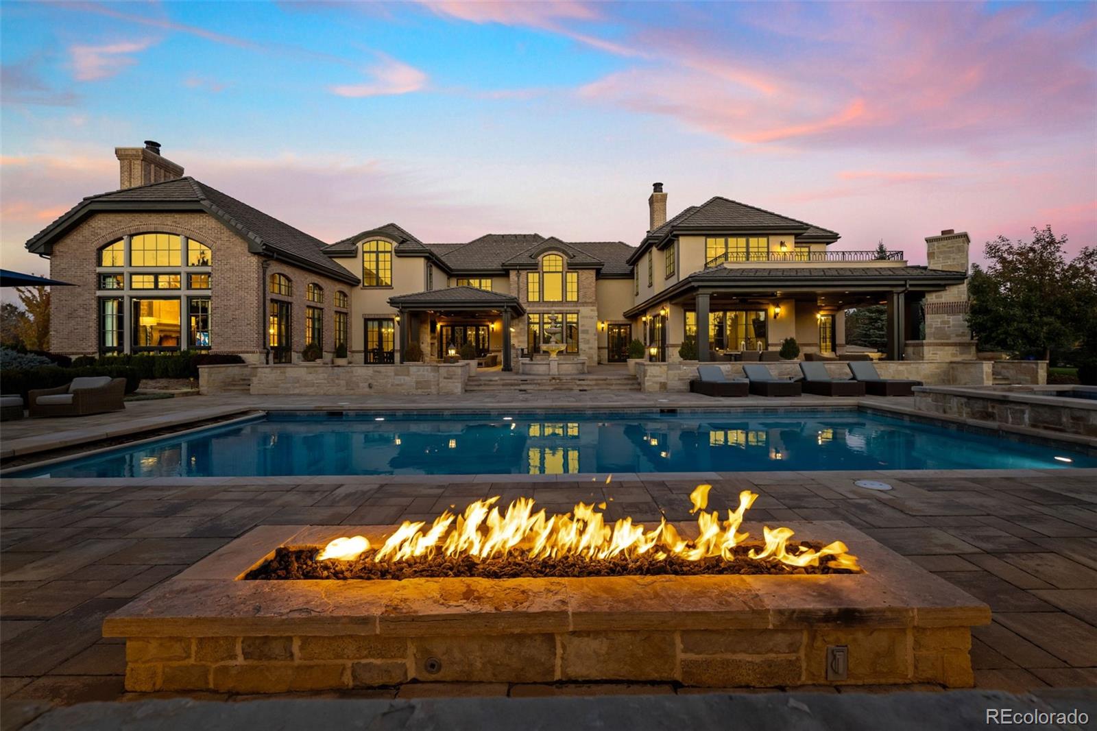 Exceptional custom residence, completed in 2017 by Bond General Contractors, ideally situated in The Preserve and distinguished by luxury finishes and thoughtful design throughout. The open-concept floor plan is anchored by a William Ohs chef’s kitchen with premium appliances, seamlessly flowing into a spacious great room, formal dining area, and a main-level office—perfect for both everyday living and elegant entertaining.The upper level features a tranquil primary suite with a spa-inspired bath, along with four additional en-suite bedrooms. The fully finished lower level offers a generous recreation room, wet bar, temperature-controlled wine cellar, guest suite, and private gym.Outdoor living rivals a private resort, with a pool and spa, pickleball court, built-in grill, and a covered patio with fireplace—an exceptional setting for year-round entertaining. Residents enjoy breathtaking mountain views, abundant natural light, and direct access to the High Line Canal Trail, ideal for walking, running, hiking, and biking.Located in a premier neighborhood with access to The Preserve’s pool, tennis courts, and scenic trails, and within top-rated schools, this home epitomizes refined Colorado living. Just minutes from the Denver Tech Center and directly across from Koelbel Library, dining, and shopping. Please see the full video tour linked below.