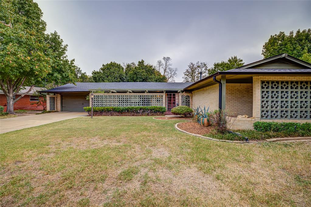 Sprawling Mid Century Ranch Style home located in Central Norman! Beautiful mature trees and landscaping line this picturesque street.  You will love the updates.  Kitchen cabinets all replaced, huge farm style sink, Quartz countertops and herringbone backsplash sets this kitchen off to perfection. Lazy susan in the corner along with rolls outs below.  5 burner gas cooktop, large oven and warming drawer for the chef in the house.  Island has a breakfast bar along with hidden spots for trash and recycling.  Large pantry and great utility room.  Lots of countertop space for a cool coffee bar, or great for serving at holidays or fall football game parties.  Tons of can lights throughout.  All interior doors were replaced with alder wood.  Circle front entry gives this home so much character.  Large picture windows in front overlook the perfect area for a front patio.  Large primary bedroom with french doors to outside with Southern exposure.  Secondary bedrooms are large with a connecting bath.  Large cedar lined closet in hallway.  Hand scraped wood floors give a warm touch.  Separate study with outside entrance is perfect for a small den, workout spot,  great office, or reading room.  Stone fireplace with gas logs is so cozy for those fall and winter days.  Extra large patio in back with pergola. Wood fencing.   Texture and paint have been updated. Nice thick baseboards are a plus.  AC is just 2 years old.  Roof is newer. 2 hot water heaters. Walk to elementary school.  Easy access to OU, shopping, I-35, Downtown Norman Restaurants, Art galleries and quaint shops.