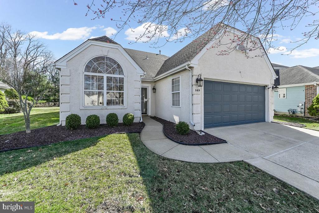 Discover the vibrant lifestyle of Holiday Village East in this inviting 3‑bedroom, 2‑full bath home featuring a versatile den, a screened‑in porch, and a comfortable outdoor patio. The attached two‑car garage offers an automatic opener and additional storage space for added convenience.   This is one of the largest lots in the community with 13,460 square feet and one of the largest homes with 2,235 square feet.  The bright eat‑in kitchen welcomes you with abundant natural light and ample cabinetry. The spacious living room easily can accommodate both living and dining furniture with an adjoining den that leads directly to the screened porch (Florida room) with custom power shades and is an ideal spot for summer relaxation or hosting family gatherings. The primary bedroom with full bath and walk in closet on the first floor is of generous size   There is a second bedroom on the first floor and a second full bath. The additional room on the second floor features a walk-in   closet and can be used as a bedroom, office, etc.  There is also a huge, floored attic on this floor with shelving.  Enjoy the ceiling fans in all bedrooms, kitchen, den, and Florida room, as well as the first-floor laundry room with washer and dryer.  Holiday Village East is known for its active, friendly atmosphere, offering a wide variety of social events, clubs, and daily indoor and outdoor activities. You’ll also enjoy being close to shopping, restaurants, personal services, and the closeness to Route 38 and Route 295 as well as all bridges to Philadelphia. Come take a look—you’re sure to be impressed