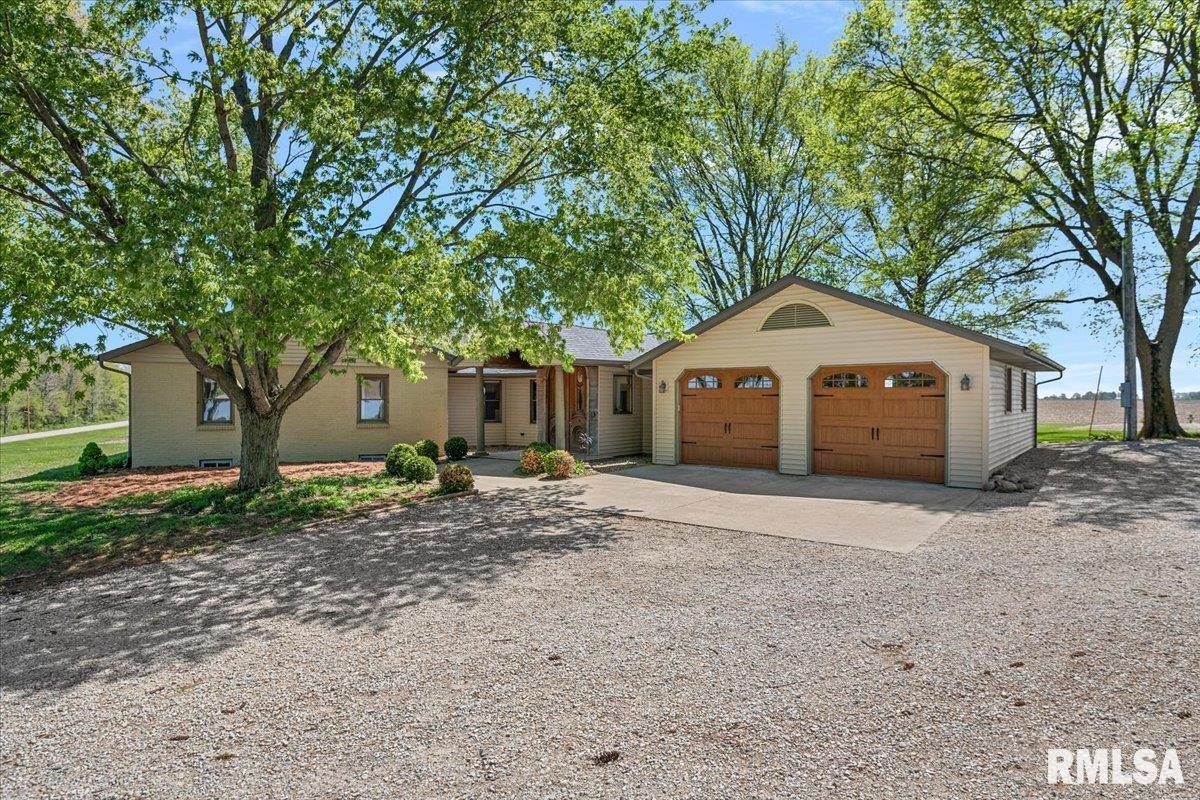 This incredible property offers 5 acres of privacy, mature trees, & versatile living spaces, plus two outbuildings, above-ground pool, full RV hookups, & dual furnace/AC/hot water heaters. Be welcomed by large arched double wood doors reclaimed from original owners family 1850's mansion. The main floor is open & spacious, featuring 3 bedrooms, 2.5 baths, kitchen, large living & dining area, family/rec/sunroom, 2 woodburning fireplaces & a dedicated office. The lower level is nearly finished (needs flooring) & includes living & dining rooms, large bedroom w/egress window & walk-in closet, multiple storage rooms w/shelving, dog bath/grooming station, & convenient stairs leading up to the attached garage. Updates include:  brand-new roof on house & detached garage w/transferrable warranty (4/2026); kit skylights; drywall & paint throughout most of the main & lower levels; completely remodeled primary bathroom with walk-in shower, dual vanity, & makeup vanity; new laundry room w/cabinets & sink; one furnace replaced in 2017; one water heater replaced in 2020; new windows in the primary bedroom & bath; new front entry/sunroom/garage doors, lighting, & trim; upgraded 6" gutters w/guards. Exterior features:  1-year-old dog run/chicken-duck coop w/built in pool (stays with property); quonset building with storage shelving and 100-amp service; brick outbuilding with 200-amp service; RV parking. This property offers room to live, work, play, and grow, truly a rare find!