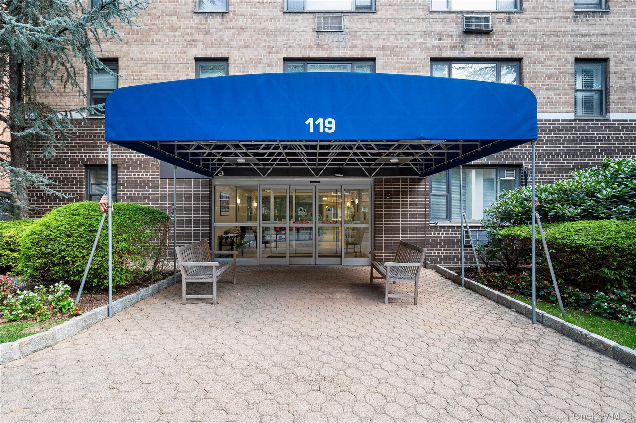 Imagine finishing a morning at the Saturday Farmers Market, just a short stroll away, and being steps from the train, shops, and restaurants—all in the heart of Hartsdale. This bright and spacious two-bedroom, two-bath home offers the perfect balance of comfort and functionality. Oversized windows fill the rooms with natural light, highlighting the warmth of the hardwood floors and creating a welcoming atmosphere throughout. The thoughtfully designed layout features a large living and dining space that flows seamlessly onto a private outdoor patio—ideal for morning coffee, dining al fresco, or simply enjoying fresh air and convenience right at your doorstep. Generous closets throughout the unit provide exceptional storage, making everyday living both practical and organized. Both bedrooms are well-proportioned, with the primary offering its own en-suite bath, ensuring privacy and ease. With laundry conveniently located on every floor, daily routines are simplified. Additional highlights include an indoor garage parking space, adding year-round convenience and value. Set in a truly central location, this residence offers the best of suburban living with city accessibility—only minutes to Metro-North for an easy commute and surrounded by local shops, dining, and seasonal community charm.