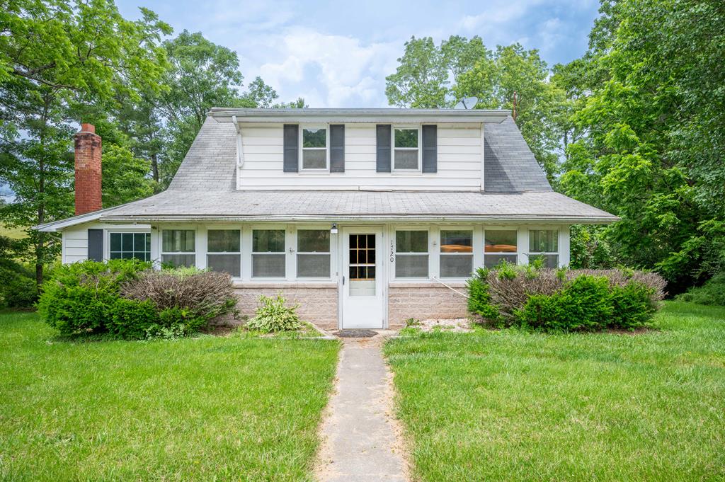 Rare Opportunity in Town Limits – Historic Farmhouse on 11 Acres! Discover the charm and potential of this 1923-built farmhouse nestled within the town limits—a truly unique offering that combines the convenience of in-town living with the beauty and space of the countryside. Situated on approximately 11 acres, this property includes 1 acre of residential zoning and 10 acres of agricultural land—an exceptionally rare find for this location. The home itself is rich in character and history, waiting for the right buyer to restore it to its original splendor. With timeless farmhouse bones, this property offers an ideal canvas for renovation enthusiasts, investors, or those seeking a one-of-a-kind short-term rental or Airbnb opportunity. Enjoy pastoral views, a meandering stream, mature trees, and a classic barn that adds to the authentic rural charm. The acreage provides plenty of room for gardens, animals, or hobby farming—all just minutes from local shops, schools, and restaurants. A carport, covered porch, and open green space add to the appeal, while the peaceful setting offers a retreat-like atmosphere with everyday convenience. The home needs TLC and updates, but the possibilities are endless for those with vision. Don't miss this chance to own a piece of local history with development potential and rural tranquility—all within town limits!