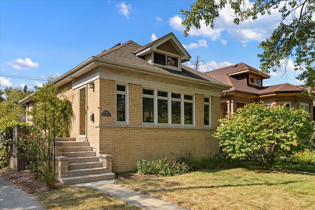 Get ready to check off all the "must have items" on your wish list! This brick bungalow sits on a corner lot, gets an enormous amount of sunlight, has been very well updated and cared for by thoughtful owners, and is in the prestigious The Villa historic neighborhood! The main level has a large living room with a gas fireplace and lovely windows that overlook the tree-lined street. The dining area is open to the living room and while it easily fits a table for 4, a table can extend into the living area for larger gatherings! The kitchen was totally renovated in 2016 and has quality wood cabinets, granite counters, and stainless steel appliances including double refrigerated drawers. Large windows and a glass door to the back yard allow loads of light into the kitchen, and easy outdoor entertaining. There is a custom built 2-tired deck out the kitchen door with a bay for a grill and built-in bench seating. The main level also features two generous bedrooms and a spacious full bathroom with a whirlpool tub! The 2nd floor is a primary suite complete with space for a king size bed, 2 large south facing skylights, a window seat at the front window, and an en-suite bathroom that was totally renovated in 2020, complete with walk-in shower, skylight, and a closet. The partially finished basement is prepped and ready for your plans! The basement was dug down in 2009 and has a perimeter drain tile and sump pump, the walls have been drywalled, there is a full bathroom (new in 2010), and lots of open space to make another bedroom/family room/recreation space.  There is a dark room equipped with a stainless steel utility sink and exhaust fan, and a laundry room with a door to access to the back yard. The back yard is fully fenced in, has a 2 car brick garage, a lovely edible garden along the south side of the home (grape vines, raspberries, a producing peach tree, rhubarb, and more!) and lots of beautiful perennial landscaping thru the property.  Enjoy sunny days and cool nights in the backyard while you watch movies on the movie screen that operates on a switch on the garage wall! This home underwent a large renovation in 2007 that included new windows and roof. The home has been updated with central heat and air conditioning. The sellers have done many updates, including basement rennovations; gas fireplace; deck; new 100amp electric panel; 2016 new kitchen and appliances; new back and front doors; refinished hardwood floors; 2020 primary bathroom; rebuilt front concrete steps and brick wall and tuckpointed chimney 2022.  Included in sale: basement fridge and deep freezer, window ac (which sellers used to supplement central ac in primary bedroom), security system, curtains/blinds, movie screen, wardrobes in bedroom, linen cabinet in bathroom.  Close to Blue Line, 90/94, Metra, Irving Park restaurants like Smoque, LaVilla, CTA Tacos, Backlot, Lou Malnati's, Eris Cider and Brewery, Old Irving Brewery, and Independence Park (with farmers markets)! If you have been looking for a home that is well maintained, move in ready, and a perfect Goldilocks size...here it is!