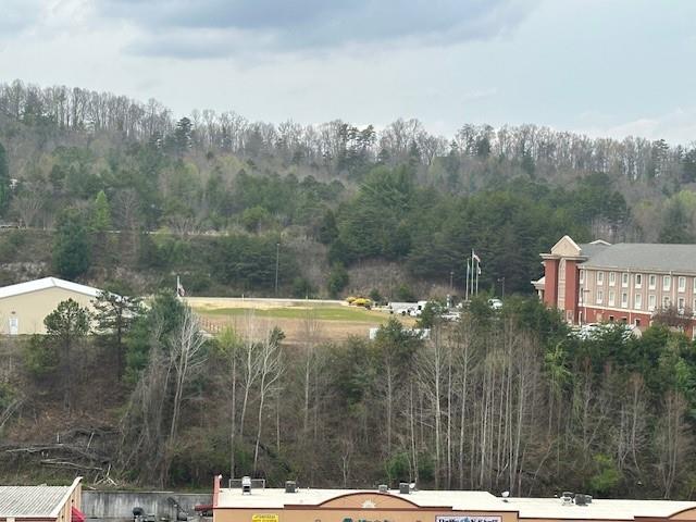 Murphy NC - Prime Commercial Vacant Land For Sale - 1.2+/-Acres Level to Gentle Rolling Land located Between two major companies "Tri state Electric which is next door to Eller & Owens Furniture & The Holiday Inn Express"  - The Road Frontage has Wide Paved Roads with Easy Access off Hwy 64 in Murphy NC  - Strategically positioned, this property is only a mile east to Downtown Murphy for Restaurants & Shopping & approximately 4 miles to the Harrah's Valley River Casino. Also an ideal location for attracting customers from various areas such as Blue Ridge, Blairsville, Hiawassee Georgia, and short distance to the Tennessee State Line. Plus, For ready & hassle free developing, this property has access to City Water, City Sewage, Electrical, Telephone & High Speed Internet connections available for your business. This Vacant Land is a Prime Real Estate Property here in Murphy NC. Not a lot of Commercial Land Available with easy access such as this property, You can easily build Your business here with minimal restrictions which offers you more flexibility for diverse business types. The land is cleared and ready for immediate development, saving you time and money. Act now to seize this prime real estate opportunity! If you are Looking For a 10-31 Tax Exchange or maybe that Perfect Hotel, Warehouse, Storage Units, This Property Offers Endless Possibilities. - Build Your Dream Business  on This Perfect Commercial Vacant Land. Don't miss out—call today to secure your future in Murphy, NC's thriving business community. Seller will Owner Finance per Buyer/Seller Negotiations.