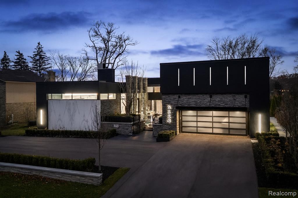 A stunning expression of modern lake-area living, this Tobocman-designed ranch estate offers over 6,700 total square feet and breathtaking panoramic views. Completely reimagined in a multi-year renovation finished in 2025, the home blends bold architectural design with refined contemporary comfort. Walls of glass create seamless indoor-outdoor flow, highlighting unforgettable sunsets and a private setting that feels resort-like year-round. Expertly redesigned with ADA-compliant accessibility, the interior features cohesive modern finishes, dramatic slab surfaces, expanded living spaces, and a beautifully crafted primary retreat. The newly added outdoor environment elevates the property even further with a mosaic-tiled gunite pool, water features, expansive porcelain terraces, an outdoor kitchen, fire elements, and full landscape transformation across the grounds. Set within a peaceful West Bloomfield enclave with nearby nature preserves and trails, this is a rare opportunity to own a true architectural statement—where luxury, design, and setting converge in one spectacular property.