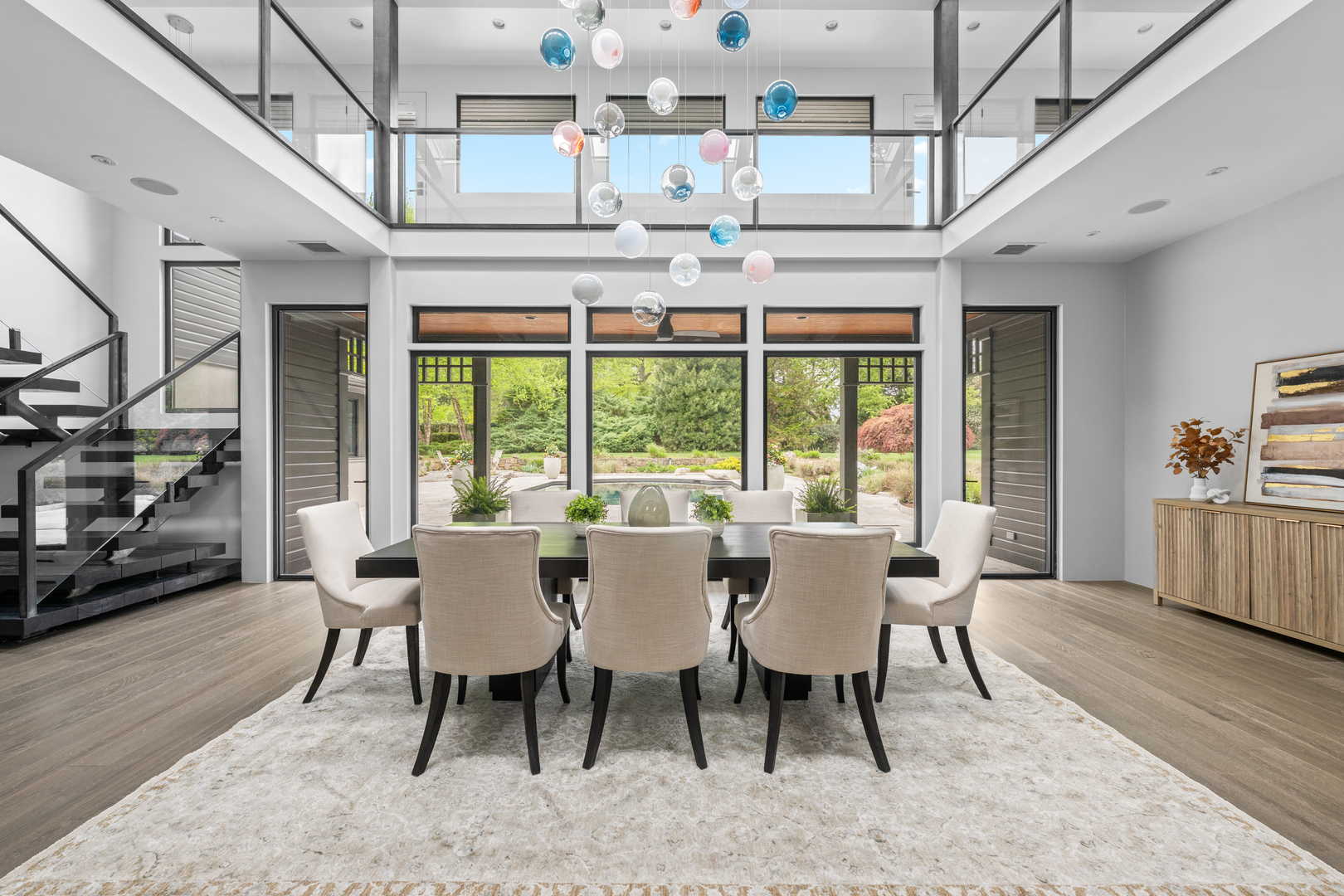 "Nestled in the heart of Villanova, 850 Lesley Rd is a modern masterpiece that seamlessly blends contemporary design with the serenity of nature. Thoughtfully updated to bring the outdoors in, this home redefines comfortable, stylish living, while connecting you to its landscape from the moment you step inside. This home is perfectly situated on two of the most breathtaking acres in Radnor Township. The living and dining areas have been unified by an open floor plan that boasts soaring ceilings and expansive glass walls, effortlessly linking indoor and outdoor living spaces. Natural light pours into the heart of the home, illuminating the exquisite resort-like pool, an impressive screened-in gazebo, with room for a dining table and sectional couch, designed by Archer Buchanan and an enchanting backyard oasis. This intelligently designed layout leads you into two distinct wings that separate family-friendly spaces from luxurious first-floor bedroom suites. Experience the seamless flow from the gourmet kitchen with a dedicated breakfast area to the library/sitting room and the family giant screen TV room with a beautiful front garden view and modern French door access to it. . Notable features include hard wood and tile flooring, stainless steel countertops, top-of-the-line commercial appliances, and magnificent cabinetry with built-ins. This area is complemented by convenient mud and utility rooms featuring elegant river rock flooring and an attached three-car garage all with extensive storage space. The adjacent wing boasts two spacious bedrooms, a hall bath, and an exceptional Primary Bedroom suite that features a spa-like bathroom retreat including a steam shower. The stunning open solid Oak staircase, also designed by Archer and Buchanan, leads you to the second floor, where a bridge spans the entire length of the house, creating a gallery that overlooks the breathtaking backyard. Each wing is thoughtfully designed, offering two bedrooms with adjoining baths, as well as two fabulous bonus rooms that can easily serve as an office, game room, gym, or studio. Outside, the flow continues with beautifully landscaped grounds that feel like an extension of the home itself. Stone pathways wind through the gardens and mature trees, leading to inviting spaces throughout the property. The partially finished basement provides additional storage. Most systems in the house have been completely updated, and now features a whole home (including outdoor pool area) mesh Wi-fi network that supports a fully automated and app controllable heating and cooling, lighting, whole house audio and video system as well as pool filtration equipment, including a salt chlorine generator. Heating and cooling is provided by five air handlers and two radiant heat hot water heater furnaces with a total of 21 heating and 13 cooling zones independently controllable and schedulable.  Most recent improvements include a completely repainted exterior, extensive tree planting, and a re-paved/sealed driveway. 850 Lesley Rd is more than just a home-it's a statement. Combining contemporary luxury with natural beauty, and the surrounding Ardrossan neighborhood, this property offers a truly elevated lifestyle in one of Villanova's most sought-after locations in the top-ranked Radnor School District."