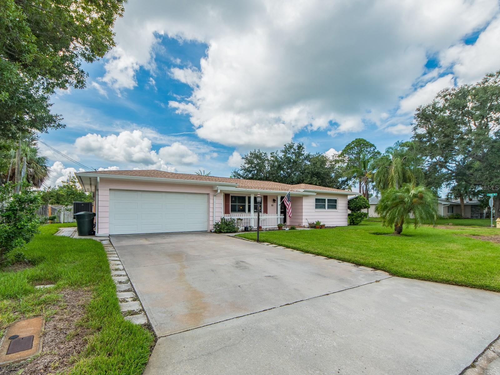 Location, location, location! Ideally just north of charming downtown Dunedin and south of the Honeymoon Island Causeway, this fully renovated gem combines coastal living with complete peace of mind. Directly across the street from Stirling Park Driving Range and St. Andrews Links Par-3 Golf Course, outdoor recreation is right outside your front door. No expense was spared on major upgrades, including a new roof, new air conditioner, and impact-resistant windows and garage door Inside, the show-stopping kitchen is a chef's dream featuring premium Café stainless steel refrigerator and range with elegant bronze accents echoed in the backsplash, high-end Bosch dishwasher and a sleek Faber square stack range hood, and quartz countertops with a dramatic waterfall edge, quartz windowsills and a custom tile backsplash Both baths present a spa-like retreat with LED touch-light mirrors featuring built-in defoggers and luxurious quartz finishes. Premium plantation shutters run throughout the home (with custom verticals in the primary suite), complemented by ceiling fans in every room and a dedicated indoor laundry room off the double car garage.