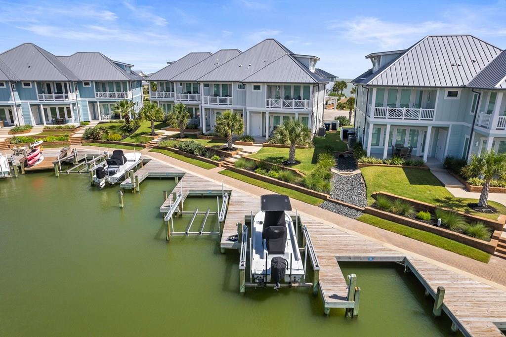 Welcome to Villa 204, a true lock-and-leave property in an exclusive waterfront community, complete with your own private boat dock and slip just steps from your back door. This beautifully designed villa offers 4 bedrooms and 3.5 baths, with an open, airy first floor featuring an spacious living area, kitchen with an oversized island and gas stove, shiplap accents, and abundant natural light streaming through large windows. Upstairs, you'll find two guest rooms with a guest bathroom, the inviting primary suite with an ensuite bathroom, and a private balcony perfect for taking in the coastal breeze. The third floor boasts a generous flex space with its own full bathroom — ideal for a bedroom, office, playroom, or even a cozy theater room. Offered fully furnished and turnkey, this property is ready for its next owners to move in and start enjoying the effortless coastal lifestyle. The community features over two miles of scenic boardwalk for morning walks, a pristine pool overlooking protected wetlands, and a pier for fishing. Located in a prime spot with world-class fishing, breathtaking wildlife, and all that Rockport has to offer, Villa 204 blends comfort, style, and unmatched waterfront living.