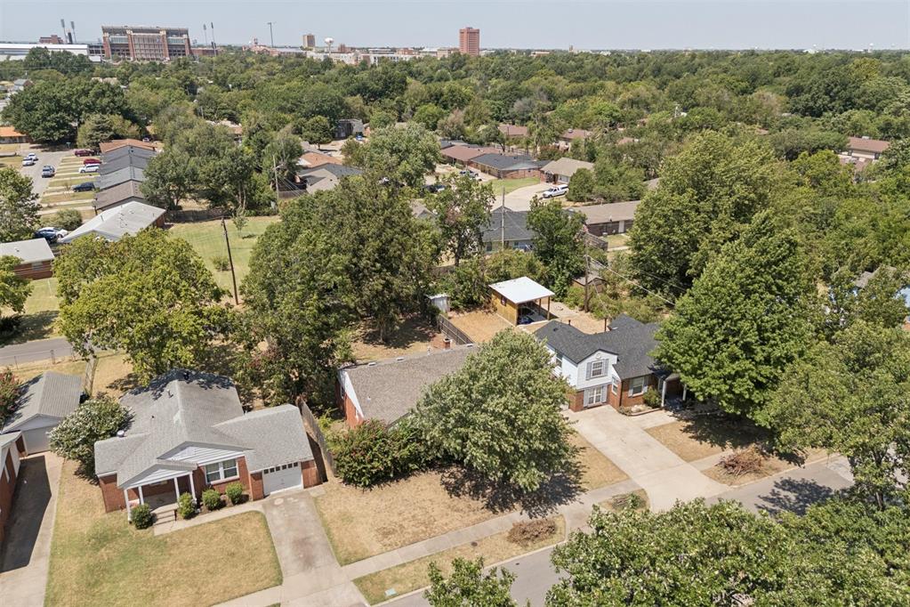 Own a piece of Faculty Heights AND be walking distance to OU's beautiful campus!! This charming campus-area bungalow beautifully blends original character with thoughtful updates throughout. Original wood floors, doors and trim have been preserved, while the open living and dining spaces create a warm, inviting feel. The updated kitchen features granite countertops, a farmhouse sink, floating shelves, subway tile backsplash, modern fixtures and stainless steel appliances. The converted garage offers a spacious third bedroom or flexible second living/bonus room. The bathroom and laundry room have both been beautifully updated, and additional improvements include newer low-E windows, hot water heater, A/C condenser and coil and ceiling fans. Outside, enjoy a large wooded lot with a great backyard, deck and charming brick walkway—all in a fantastic location near campus!