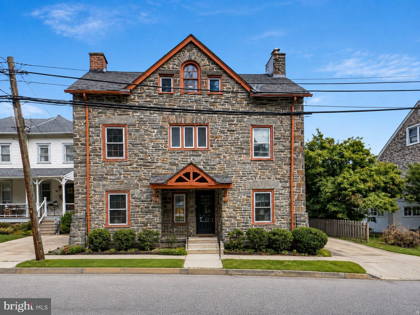 Originally built in 1906 as the gatehouse to one of the Main Line’s grand estates, this charming historic stone home is truly one-of-a-kind. Now it is looking for its next owner, someone who will become the next keeper of this special home and its history. From the moment you arrive, the character is unmistakable, with a gated front porch, original hardwood floors, built-ins, deep-set windows and a beautiful fireplace. The first and second floors feature original hardwood flooring, neutral interiors that provide a warm and inviting backdrop for the next chapter of this home. The updated kitchen features classic white cabinetry, black granite countertops and stainless-steel appliances. The second floor offers two bedrooms, each with its own bonus sitting room, providing flexible space that could easily serve as a home office, reading room, dressing room, art studio or playroom. The updated second-floor bathroom features a stall shower. The third floor offers two additional bedrooms and a hall bathroom, creating even more flexibility for guests, family, hobbies or workspace. These versatile rooms allow the home to adapt to the way you live today while preserving the charm of its original design. Major systems have been thoughtfully updated, including high-velocity central air and 200-amp electrical service, offering modern comfort and peace of mind while maintaining the integrity and character of this historic home. Outside, enjoy a private brick patio, fenced outdoor space and detached one-car garage.  And the location is hard to beat! Walkable to Bryn Mawr Hospital, downtown Bryn Mawr, restaurants, shopping and the train station, with easy access to everything the Main Line has to offer and located in Radnor School District. This isn’t simply a house; it’s a home with a story. Built in 1906, it has been cared for, lived in and loved through generations of change and now it is waiting for its next owner to become its keeper. If you appreciate historic character, thoughtful updates and a home that feels truly special, this Bryn Mawr gem deserves a closer look.