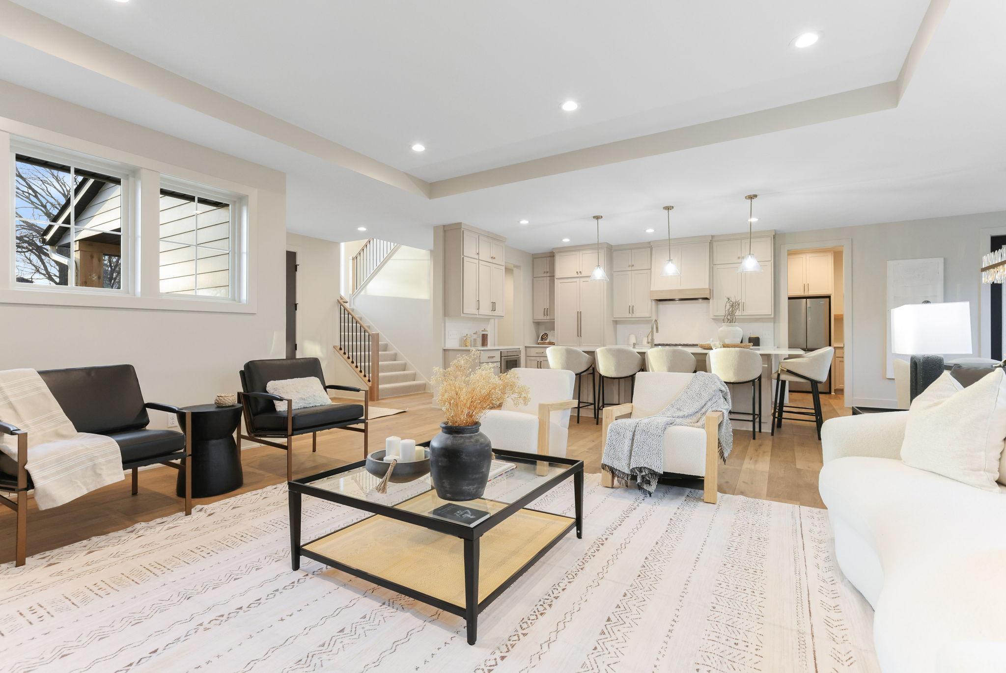 Exceptional new custom-built home by Stone Cottage Construction on a desirable corner lot in a sought-after Edina neighborhood! This stunning two-story home offers 6 bedrooms and 5 bathrooms with thoughtful design and high-end finishes throughout. The gourmet kitchen features a center island, soft-close cabinetry, Thermador Appliances and a spacious walk-in pantry—perfect for entertaining and everyday living. The open-concept main level showcases beautiful white oak hardwood floors, Andersen windows, and a welcoming Great Room with a gas fireplace. A versatile main-floor bedroom provides flexibility for guests or a home office. Upstairs, all four bedrooms include walk-in closets, and the luxurious primary suite features a spa-inspired ensuite bathroom. The finished lower level offers a generous family room, wet bar, sixth bedroom, and ¾ bath—ideal for gatherings and relaxation. The insulated garage has a rough-in gas line for a heater as well as a floor drain which adds convenience year-round. Nestled in the award-winning Edina School District, this home combines quality craftsmanship with timeless style.
